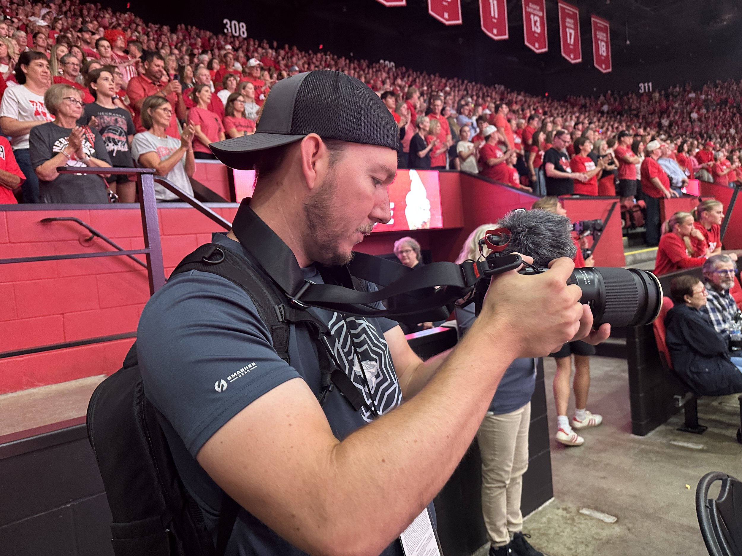 Dylan filming a volleyball event from the stands.