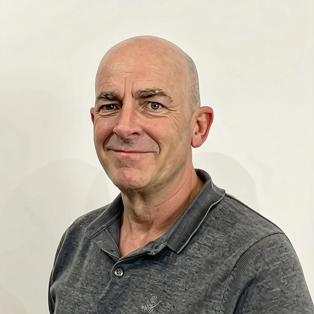 Headshot of Neal, a gentleman with no hair, smiling at the camera.