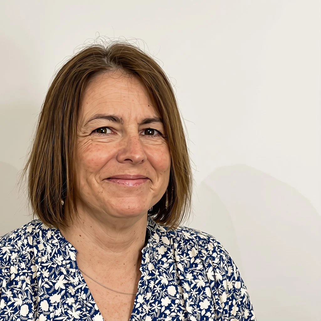 headshot of Jan, with short bobbed dark hair, smiling at the camera.