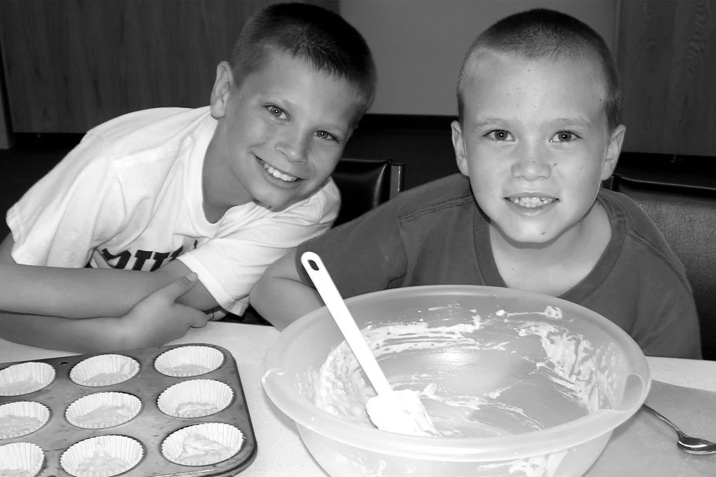 2 boys mixing a batter for muffins