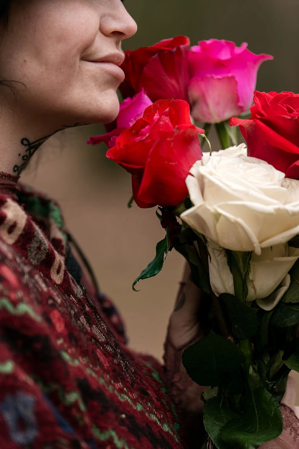 woman smells roses with joy