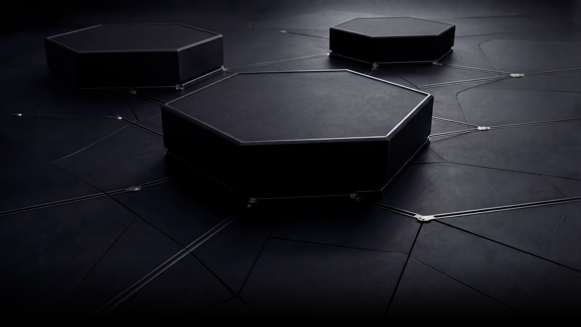 Three interconnected black hexagonal platforms with metallic edges on a dark surface, connected by thin metallic rods.