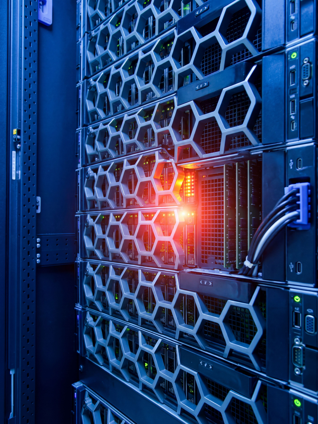 Close-up of server racks in a data center with blue lighting and red indicator lights.