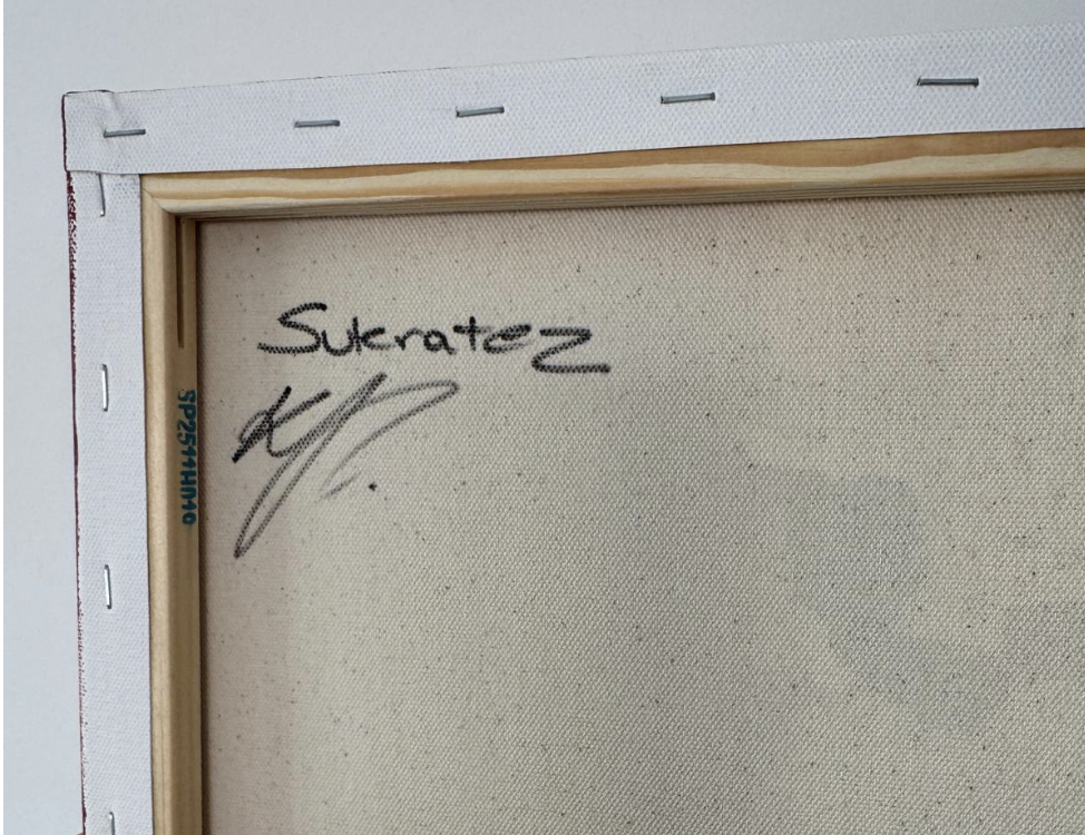 Back of a canvas painting with a signature and the name 'Sukratez' written on it.