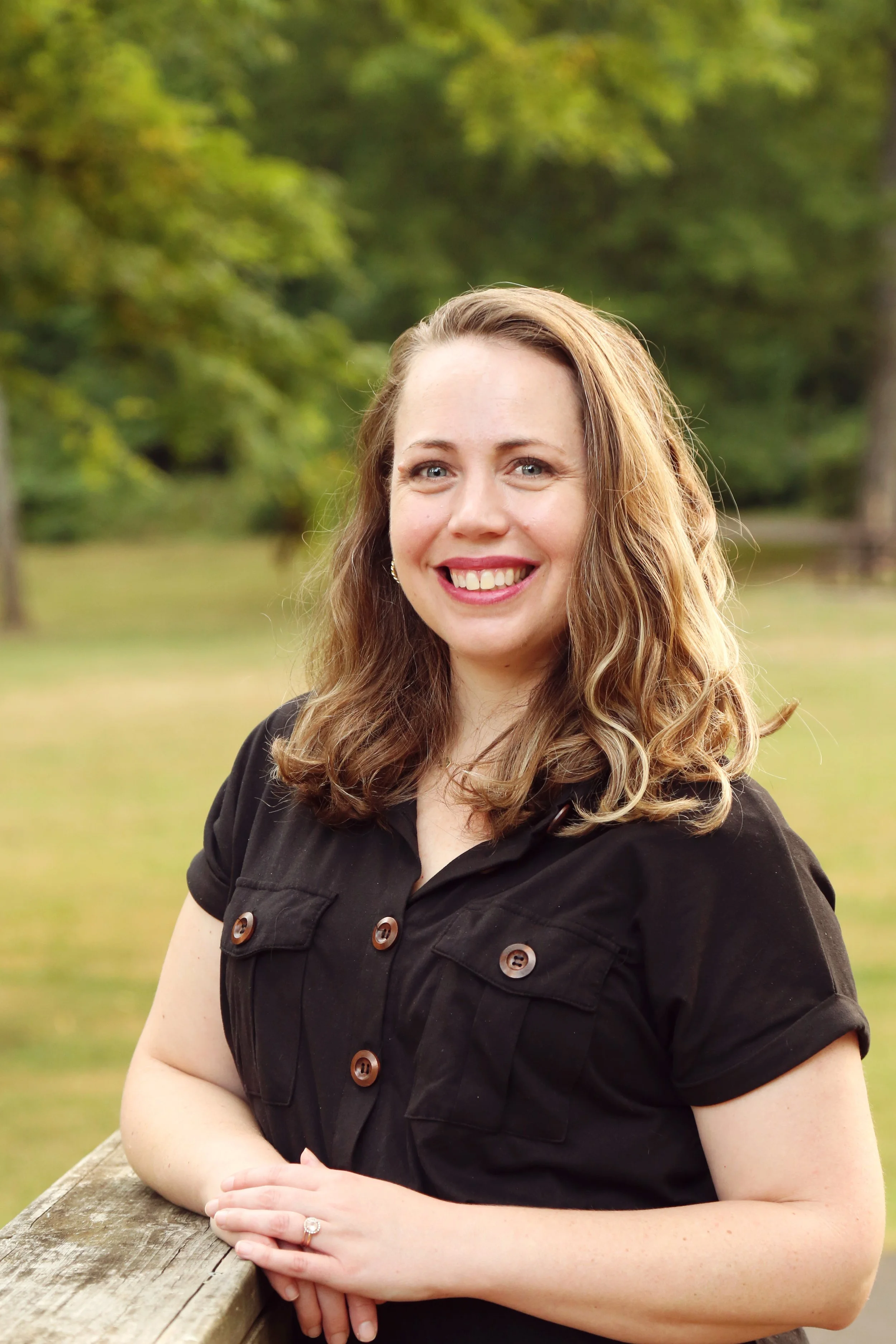 Tara Quick, Christian EMDR therapist, standing outside smiling in the sun.