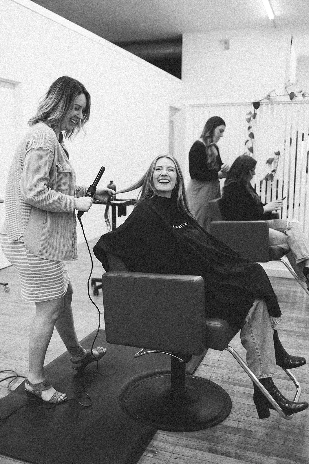 Paige McDowell styling a client's hair in a salon in Lynden, Washington