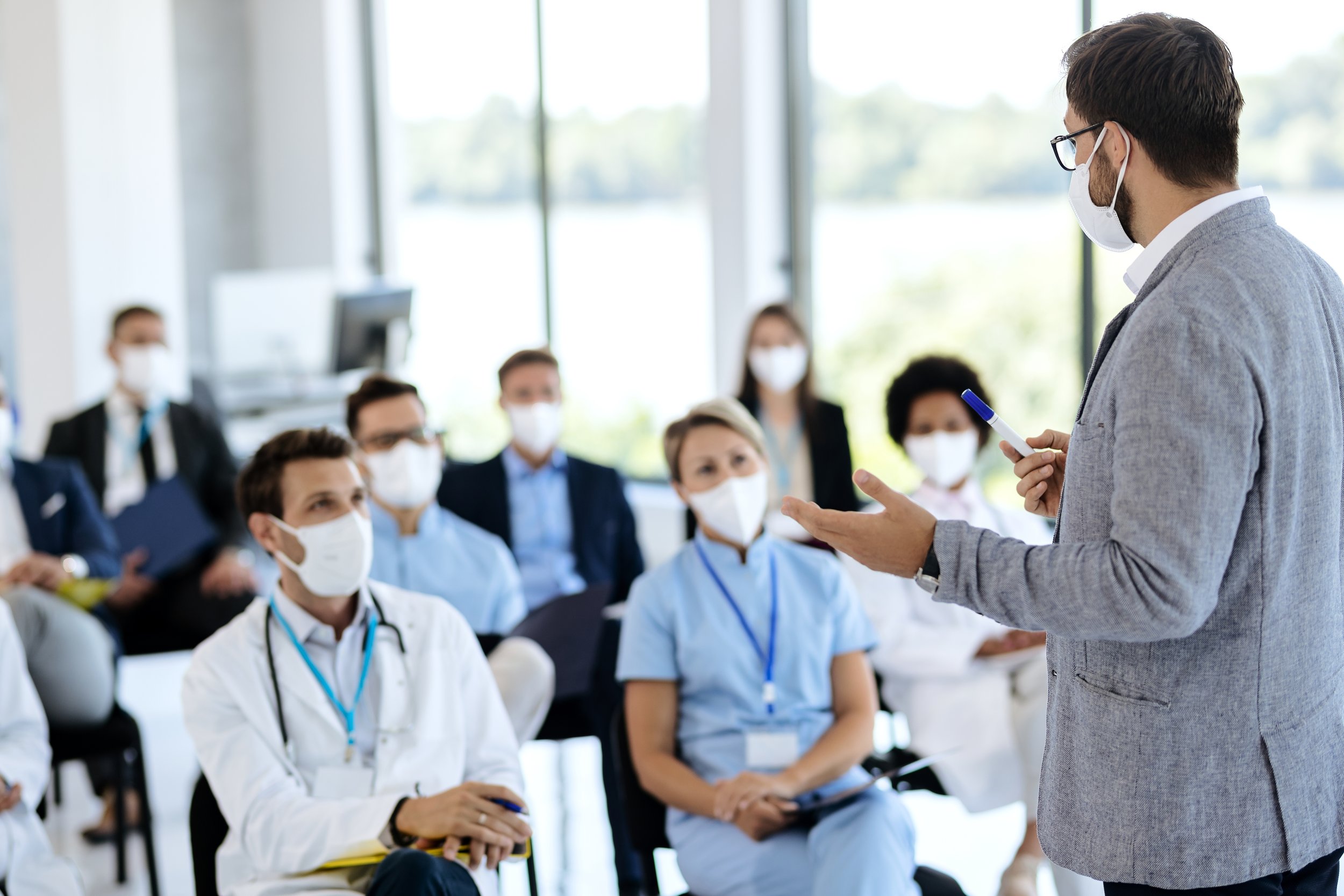 businessman-with-face-mask-giving-a-presentation-t-2026-01-06-10-28-06-utc.jpg