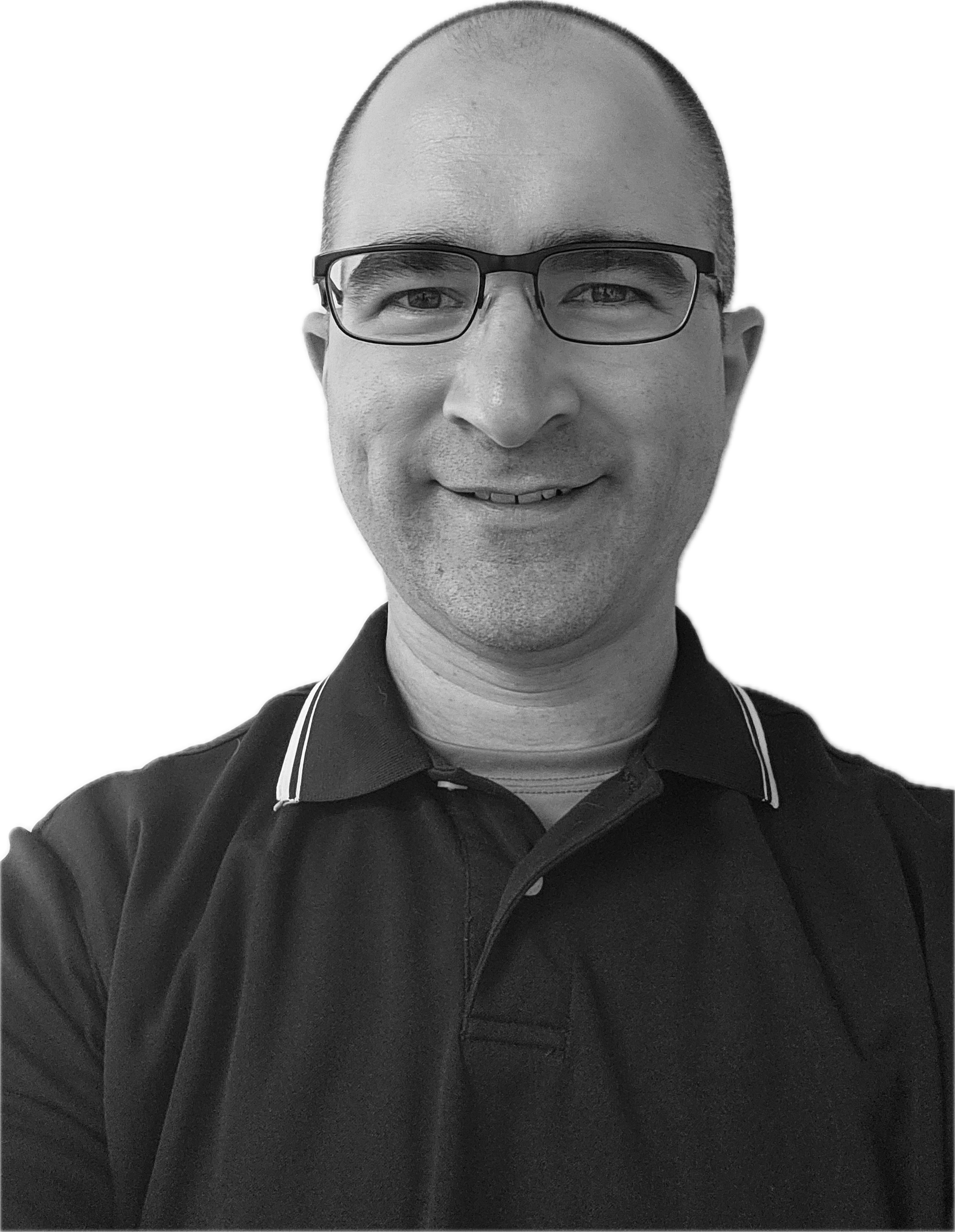 Black and white photo of smiling man wearing glasses and a collared shirt.