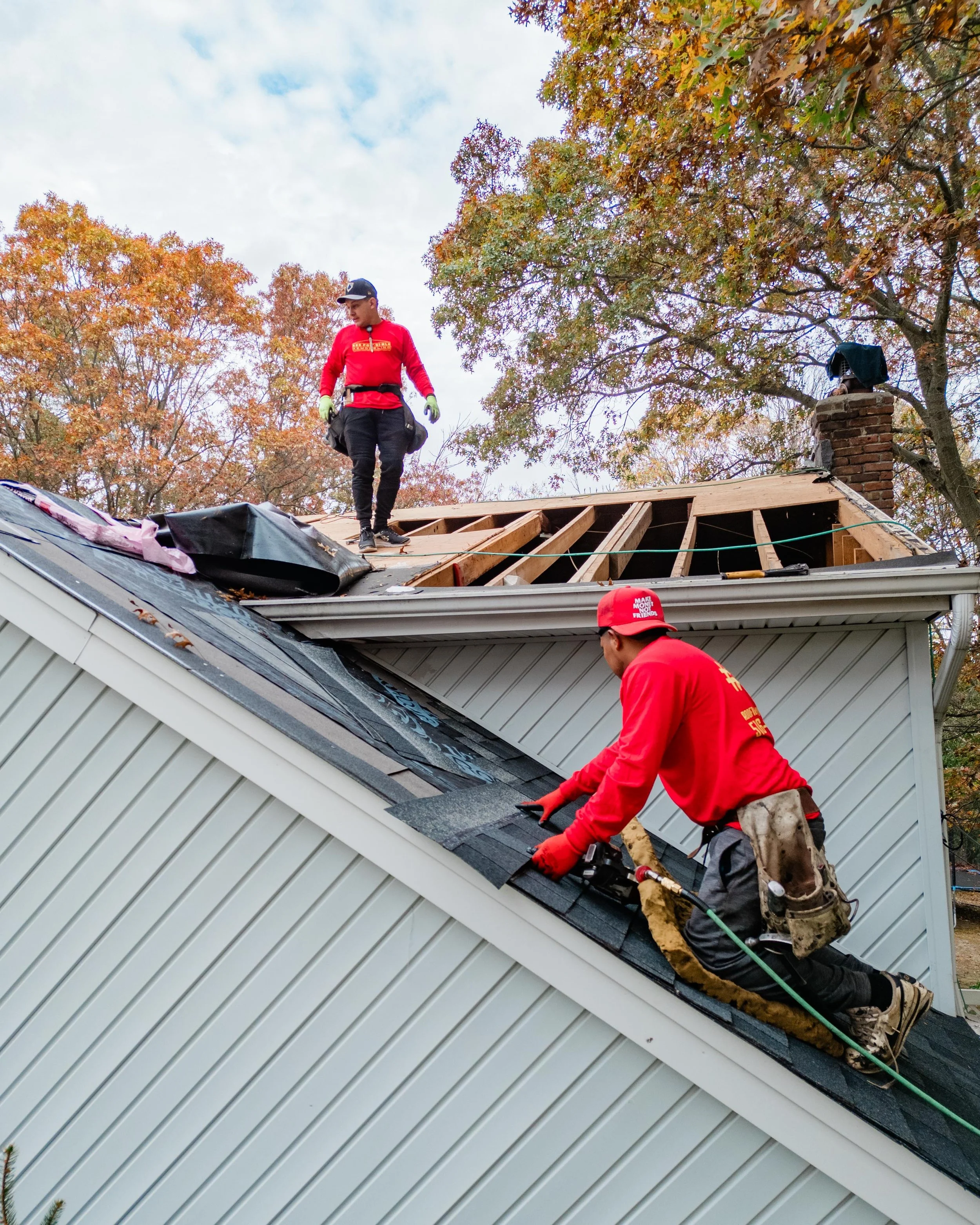 Responsible Remodeling Employees Adding Wood and Shingles To Roof