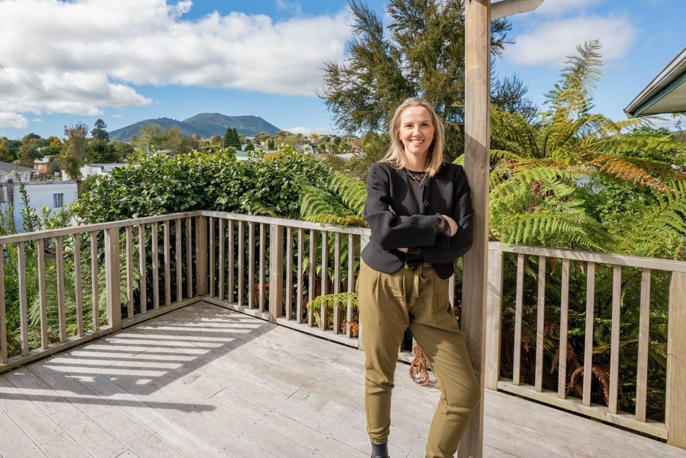Chelsea Higgott on the deck, Lake Taupō in the background