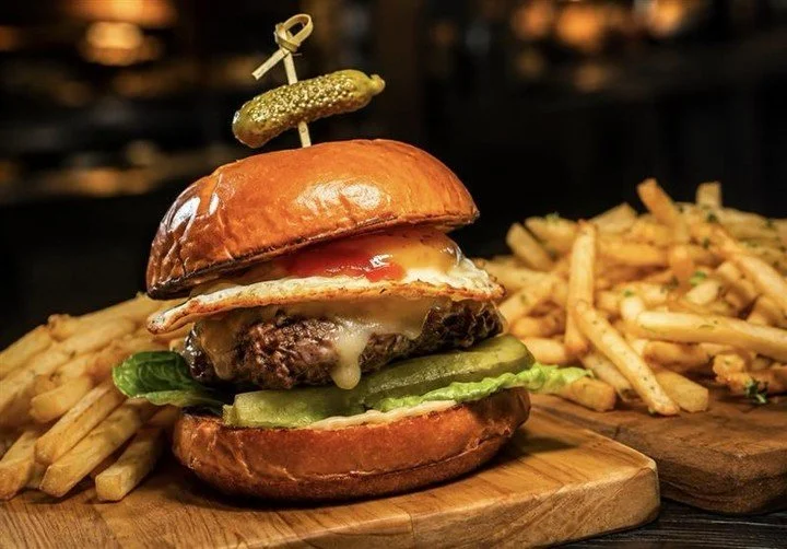 Come try this amazing addition to our menu, the Cheval Camburger. A French-inspired upgrade to our current CamBurger, topped with a fried egg and bacon jam. &ldquo;&Agrave; cheval&rdquo; is the traditional French term used for a dish served with a fr