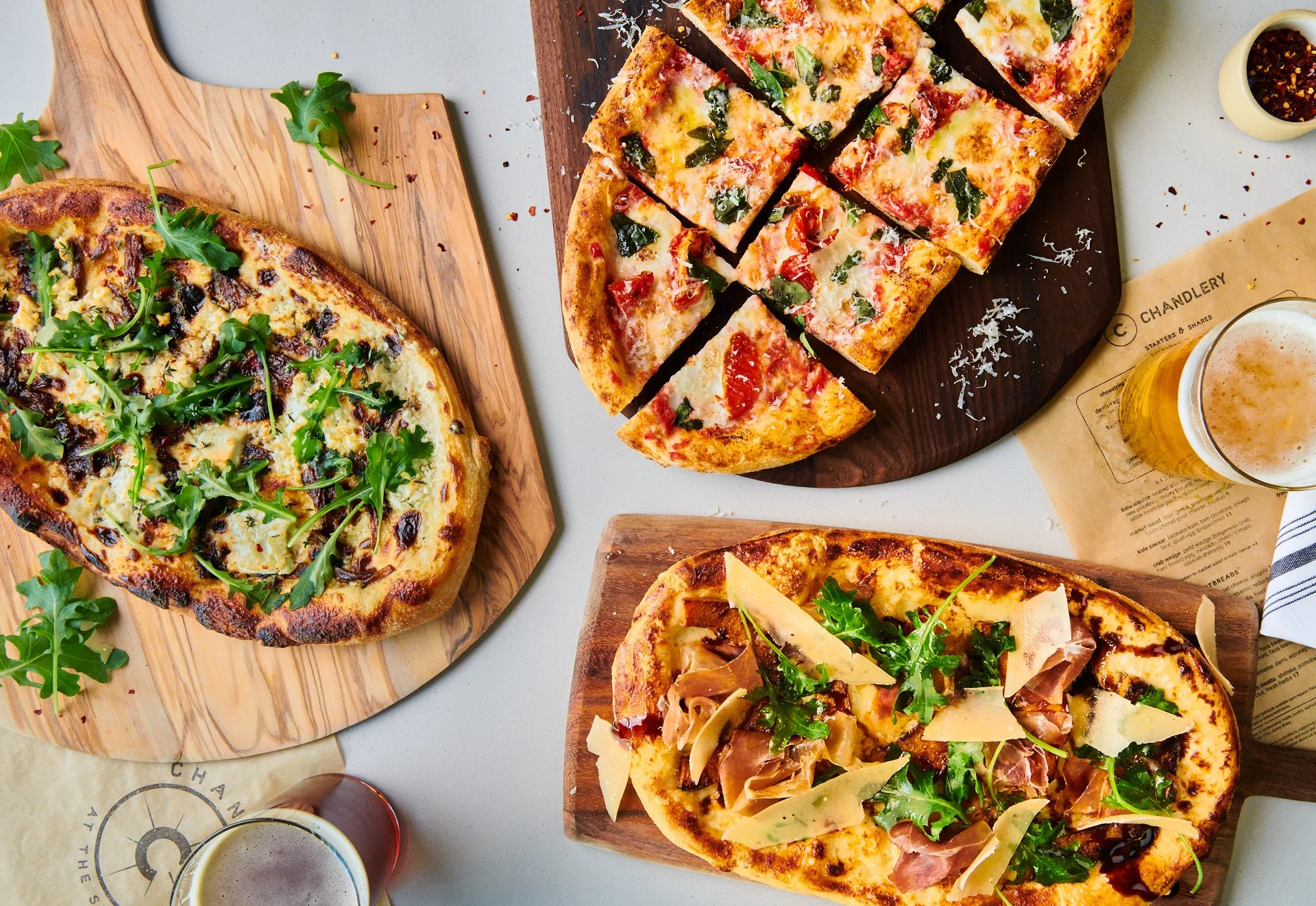 pizzas and beer take top down with beer and menus for framing