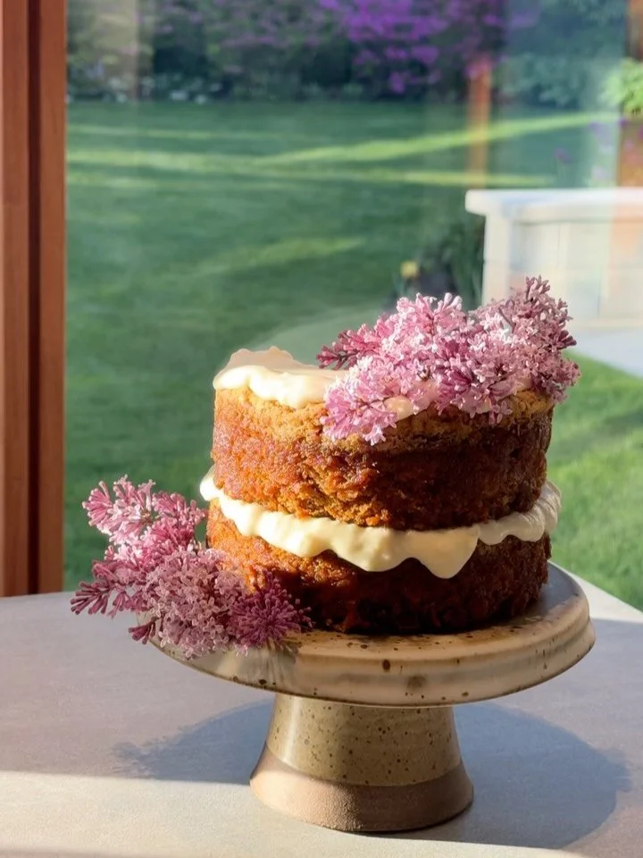 Mother&rsquo;s Day carrot cake on a handmade cake stand with lilac from the garden #pottery #ceramics #cake #garden