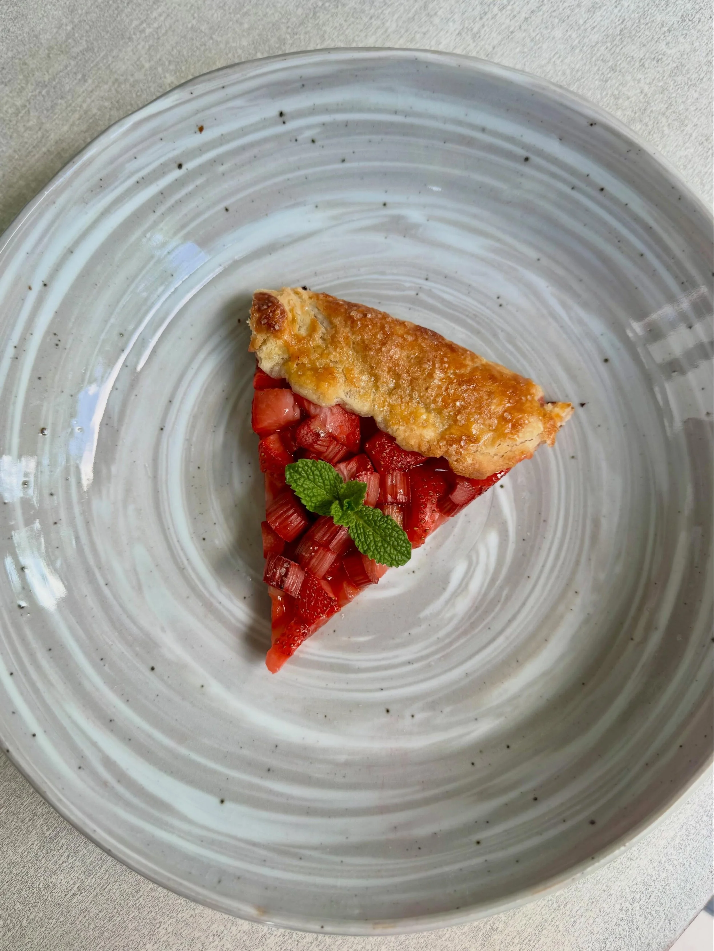 Strawberry rhubarb (from the garden!!!!) galette in a marbled plate (made in middle school) 
#pottery #ceramics #farmtotable #rhubarb