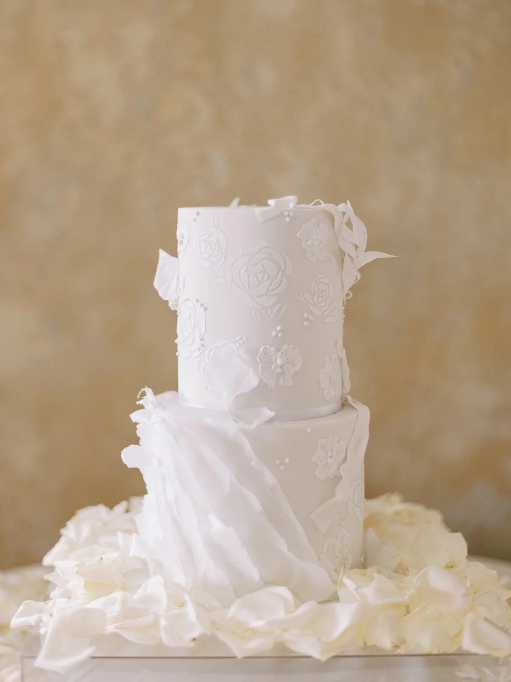 all white wedding cake with flowers
