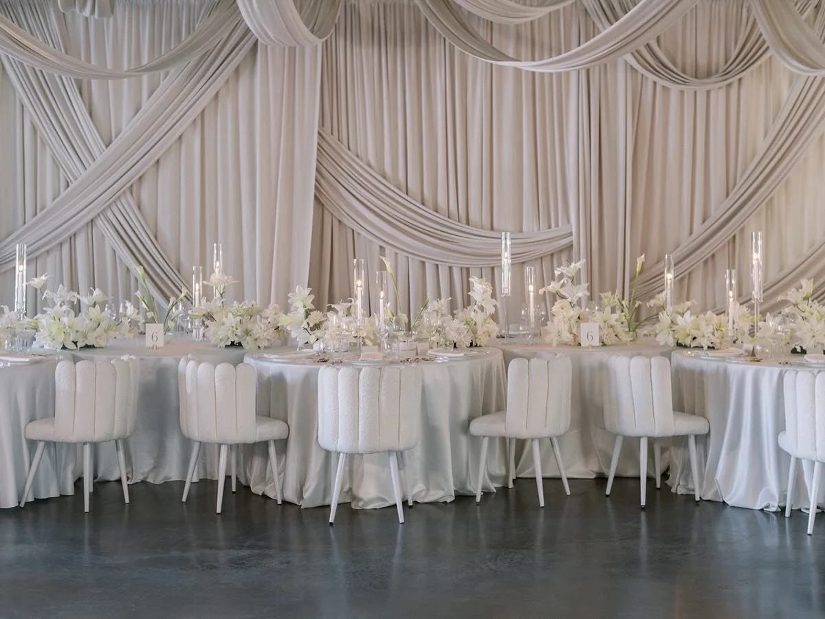 Last years workshop designed by @julianneyoungweddings was nothing short of amazing. The drapery was perfect, and the lillies by @alexandravictoriarose⁠ were flawless. Who knew the pantone color of the year would be white 😂 The whole wedding industr