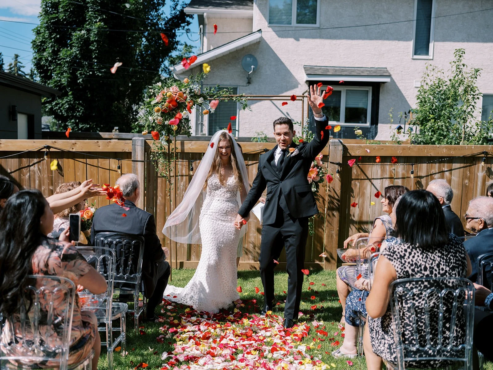 aisle exit or processional from intimate wedding ceremony in the couples backyard 