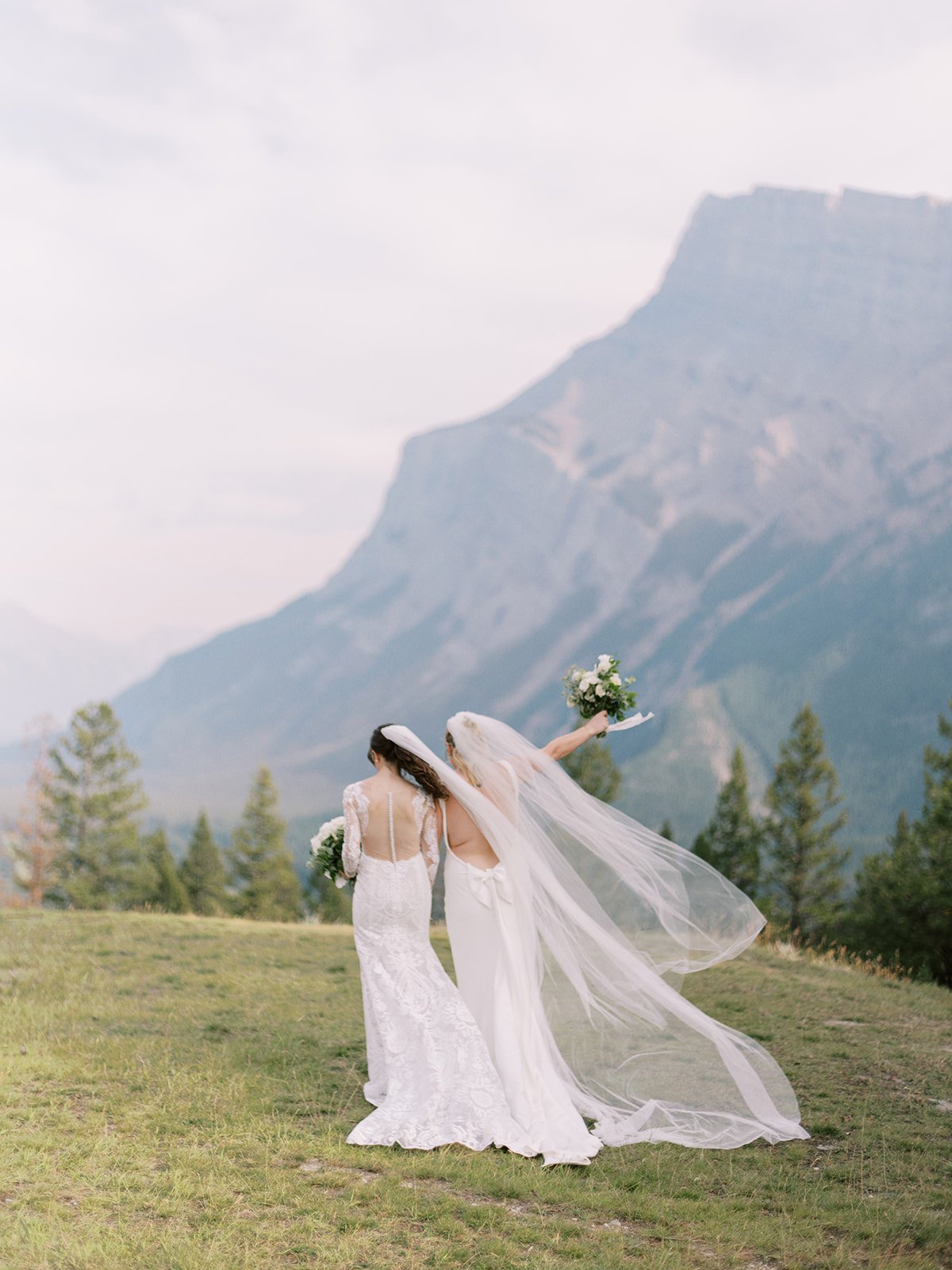 same sex couple celebrate wedding at tunnel mountain in banff
