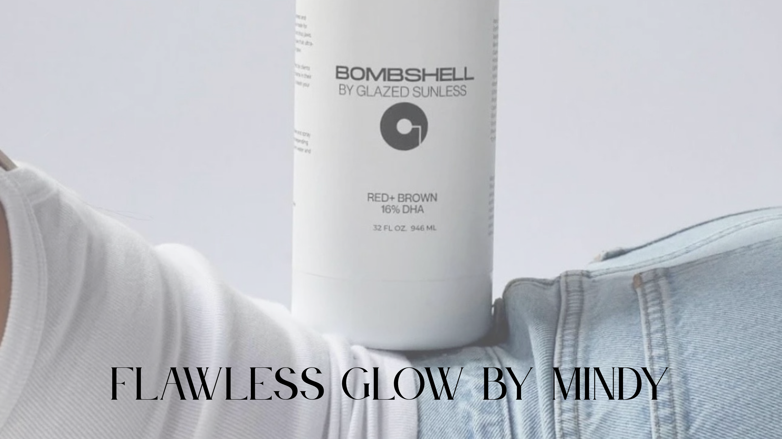 A white bottle of Bombshell by Glazed Sunless self-tanner labeled RED+ BROWN, with 16% DHA, held against the background of a person's arm and denim pants, with text overlay reading Flawless Glow by Mindy.