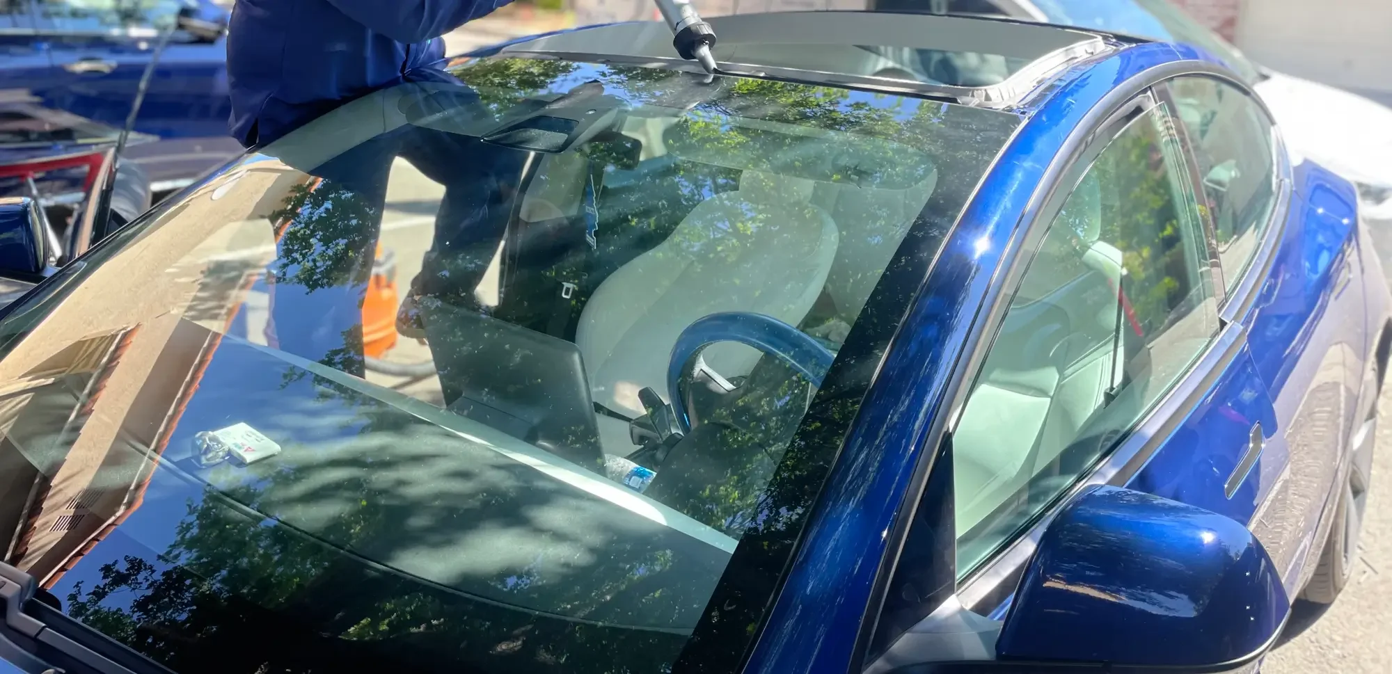Technician performing professional windshield replacement on a vehicle