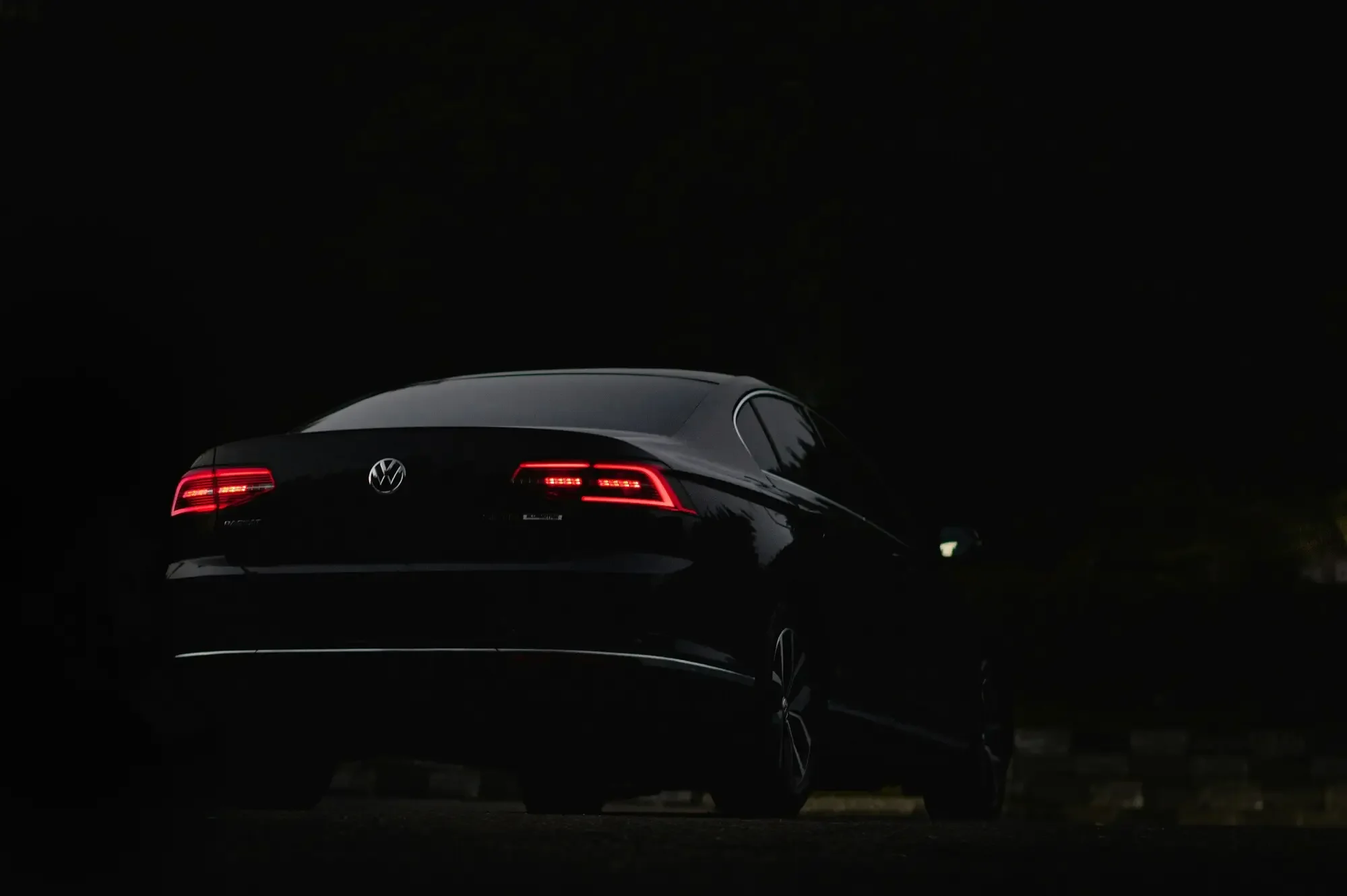 Black Volkswagen with rear window and auto glass at night