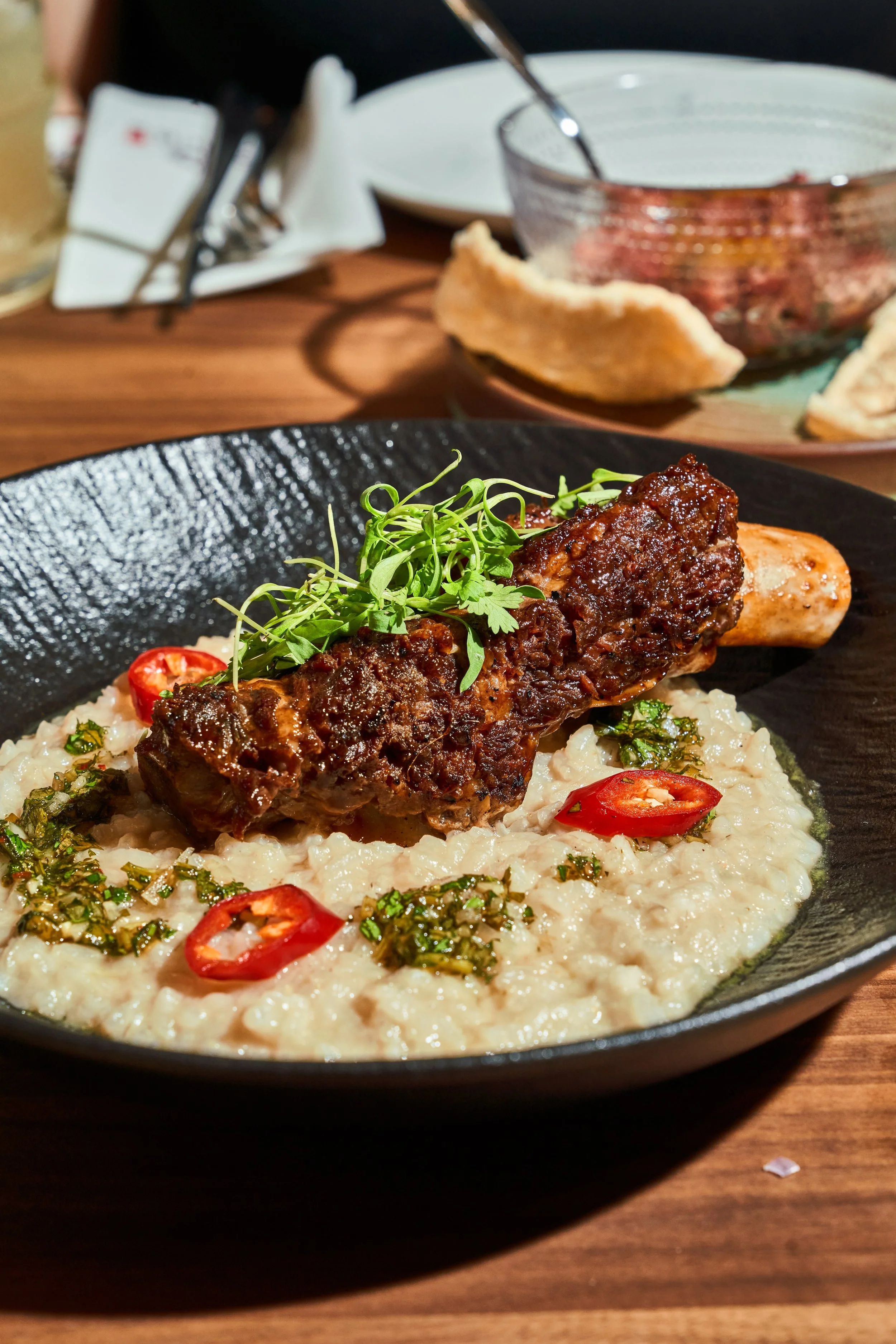Beef rib over pho risotto with herbs and chili at Le Soleil Stonestown