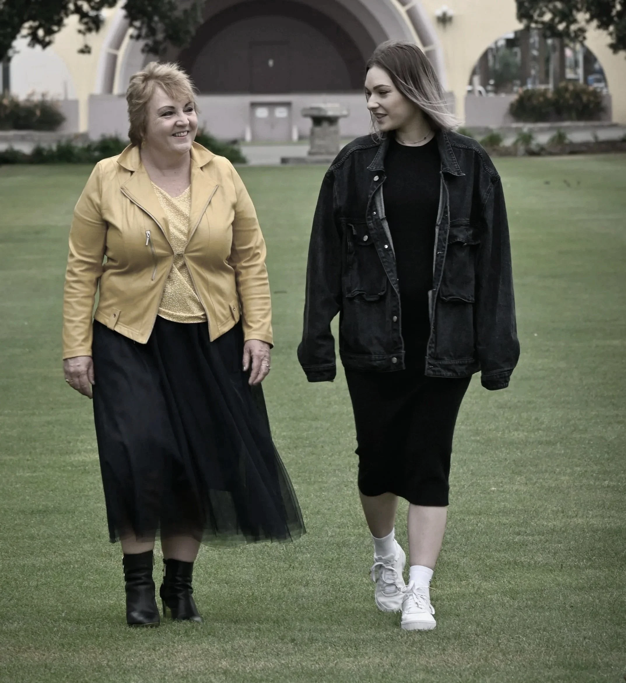 Mother and adult daughter walking together during a conversation about identity, belonging, and growing up between cultures.
