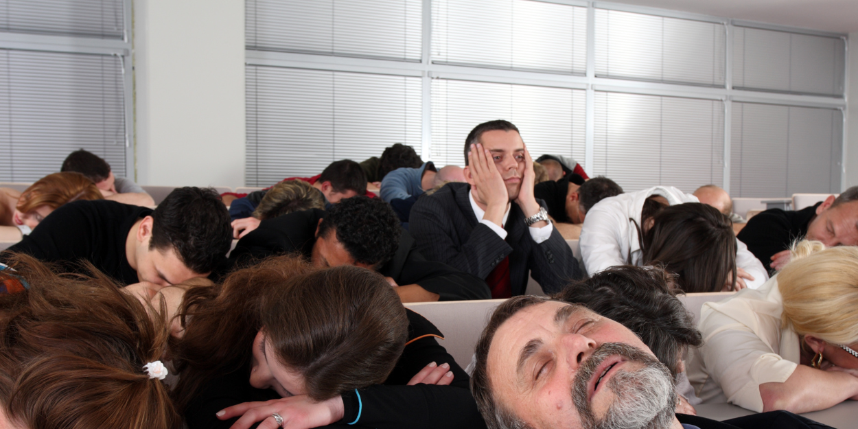 Group of people asleep in a classroom or conference room