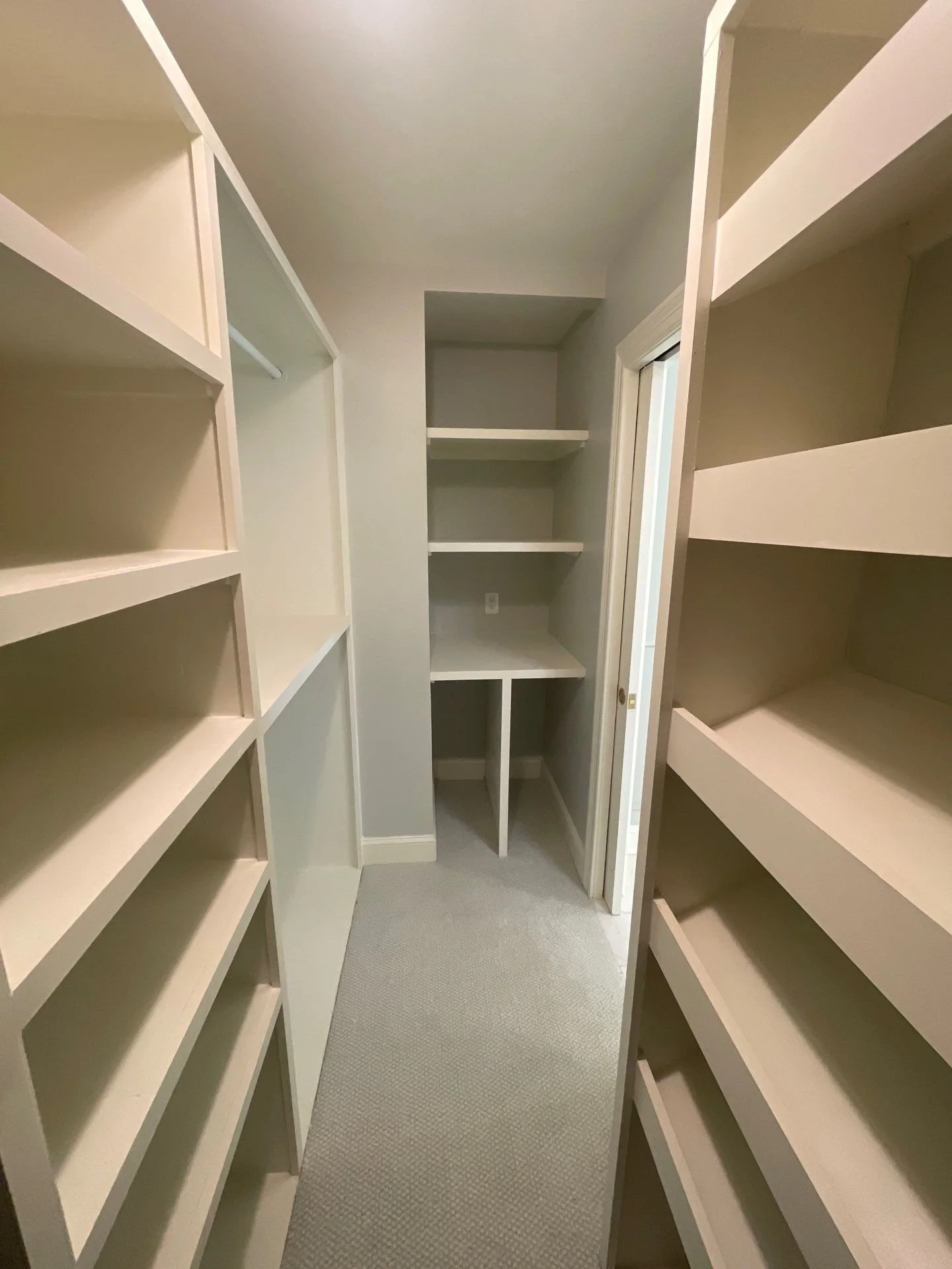 An upgraded walk-in storage solutions of a bathroom remodeled by Modern Handymen