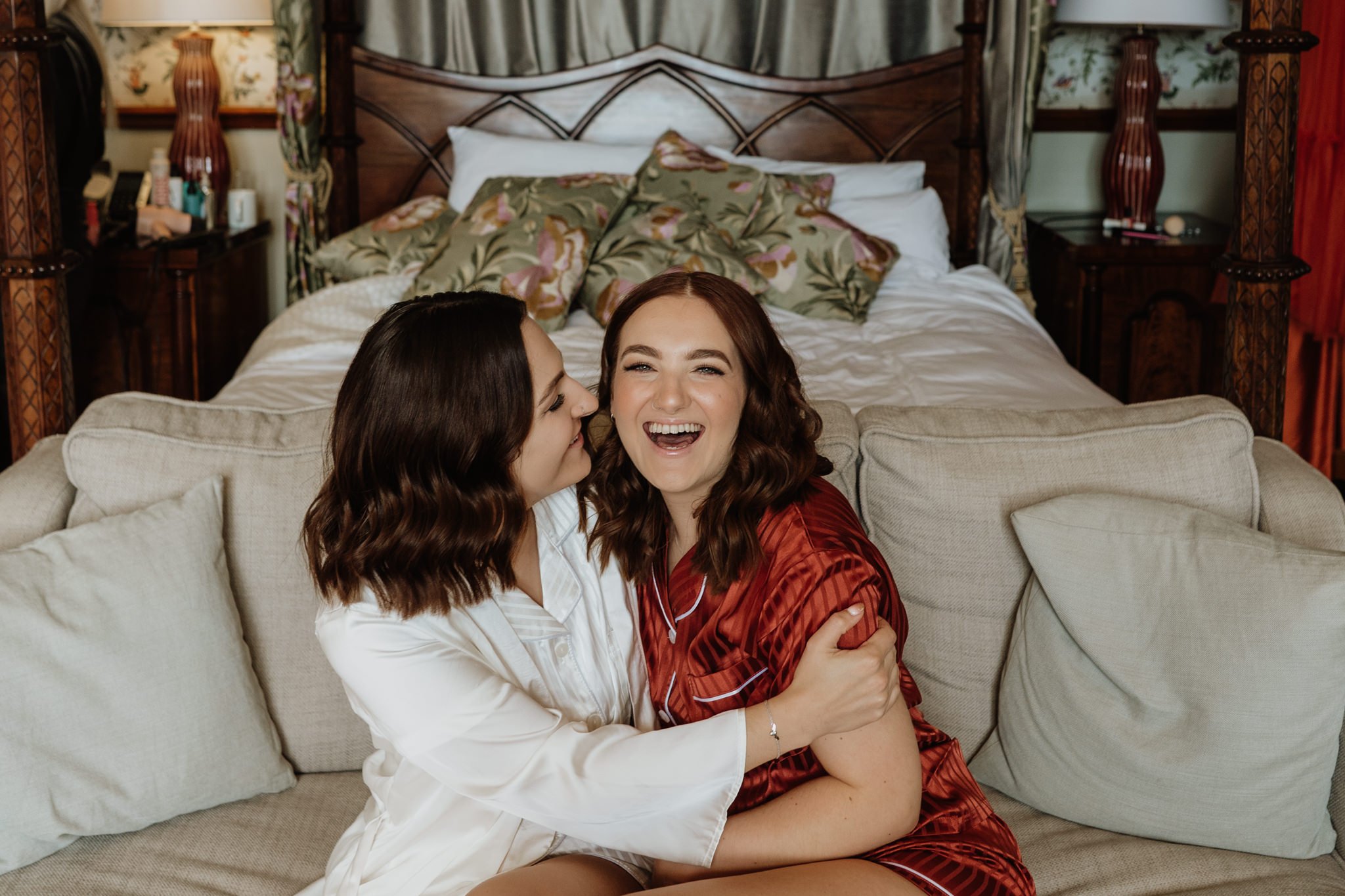 bride and sister hugging and laughing