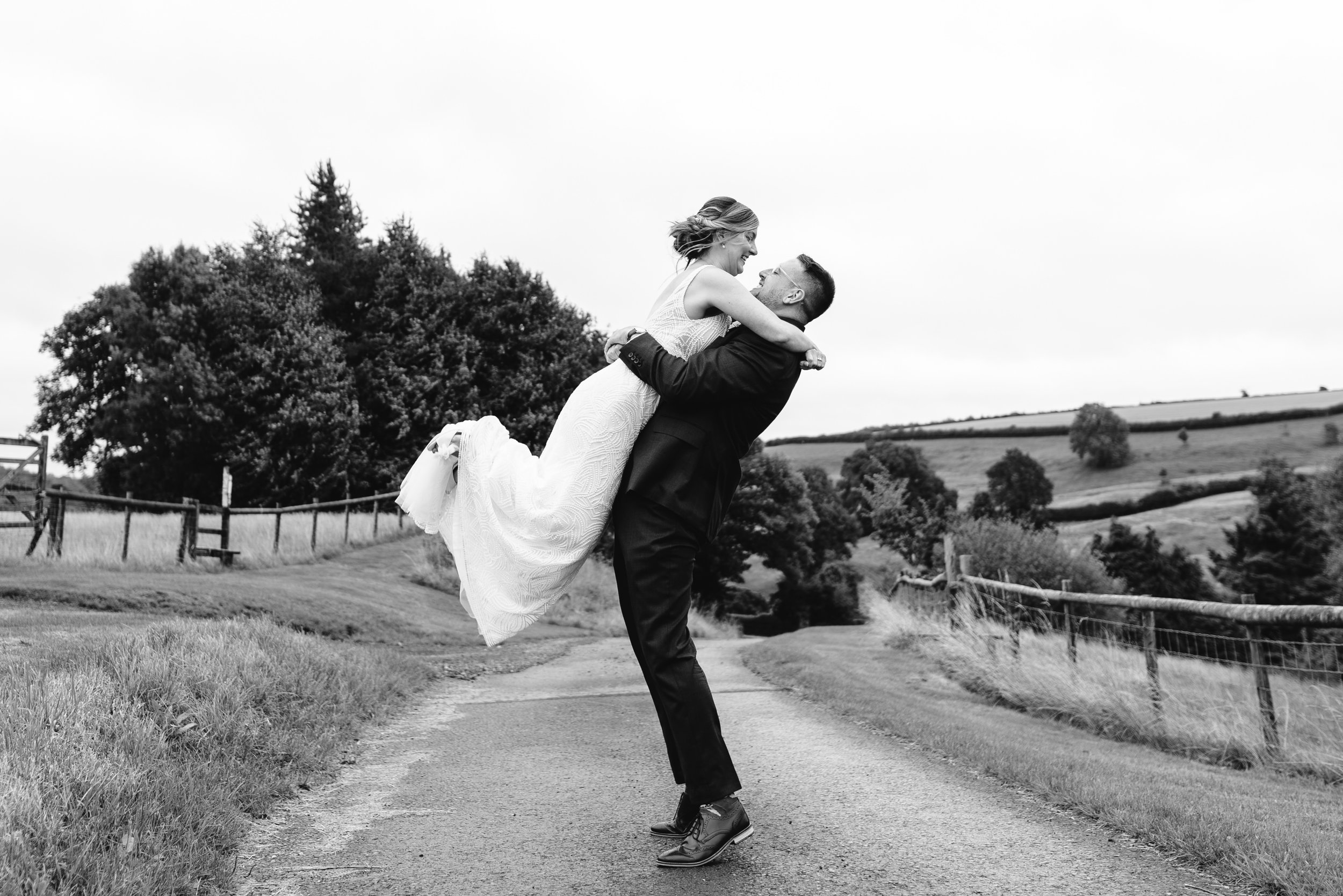 groom picks up the bride on rural road