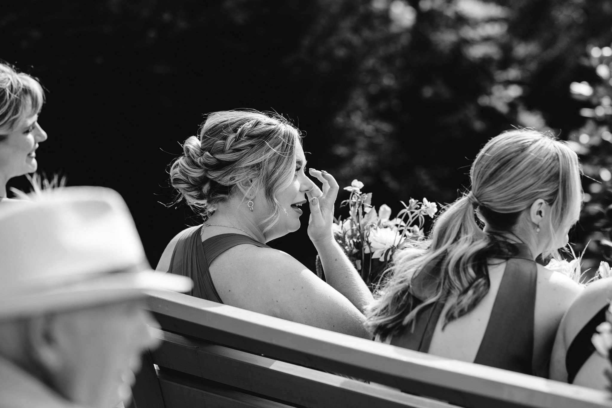 candid black and white photo of guest crying during outdoor ceremony