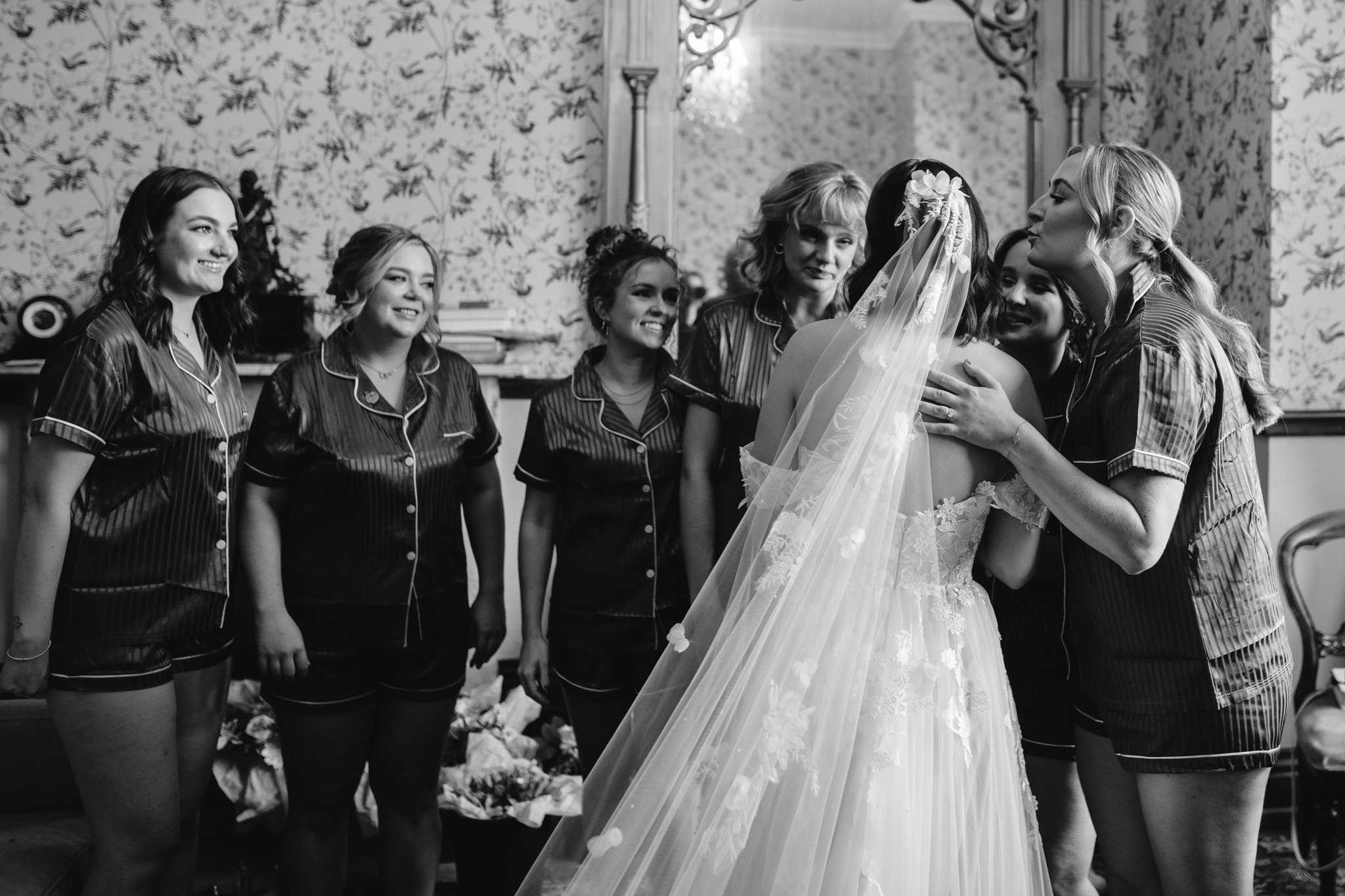 bride hugging bridesmaids