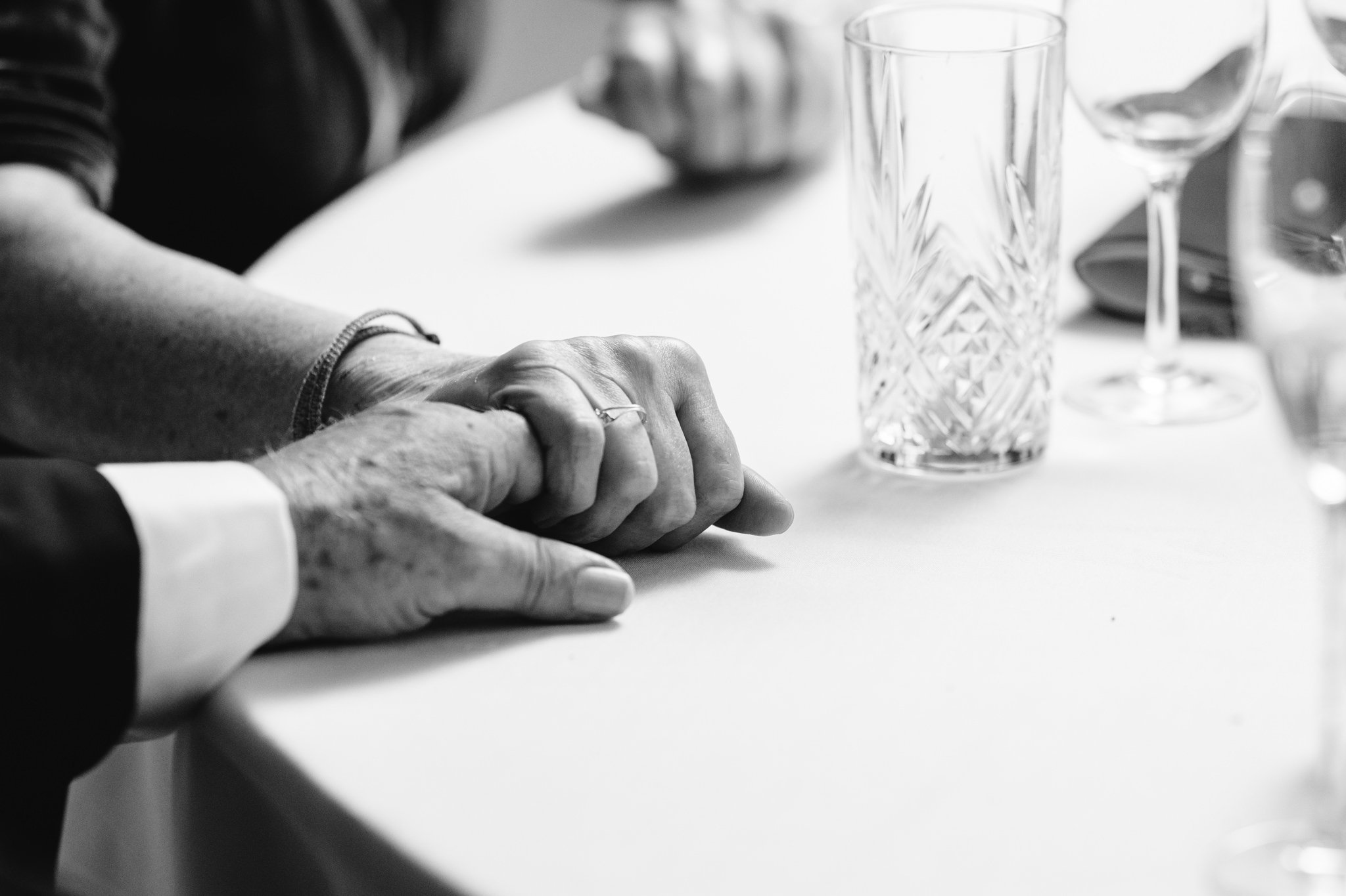 black and white photo of hands holding