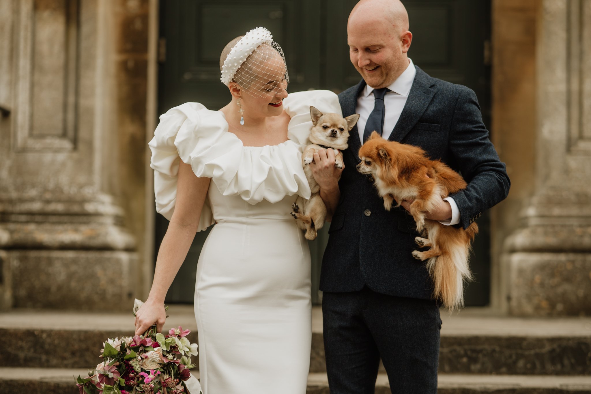 alternative bride and groom holding their dogs at arnos vale