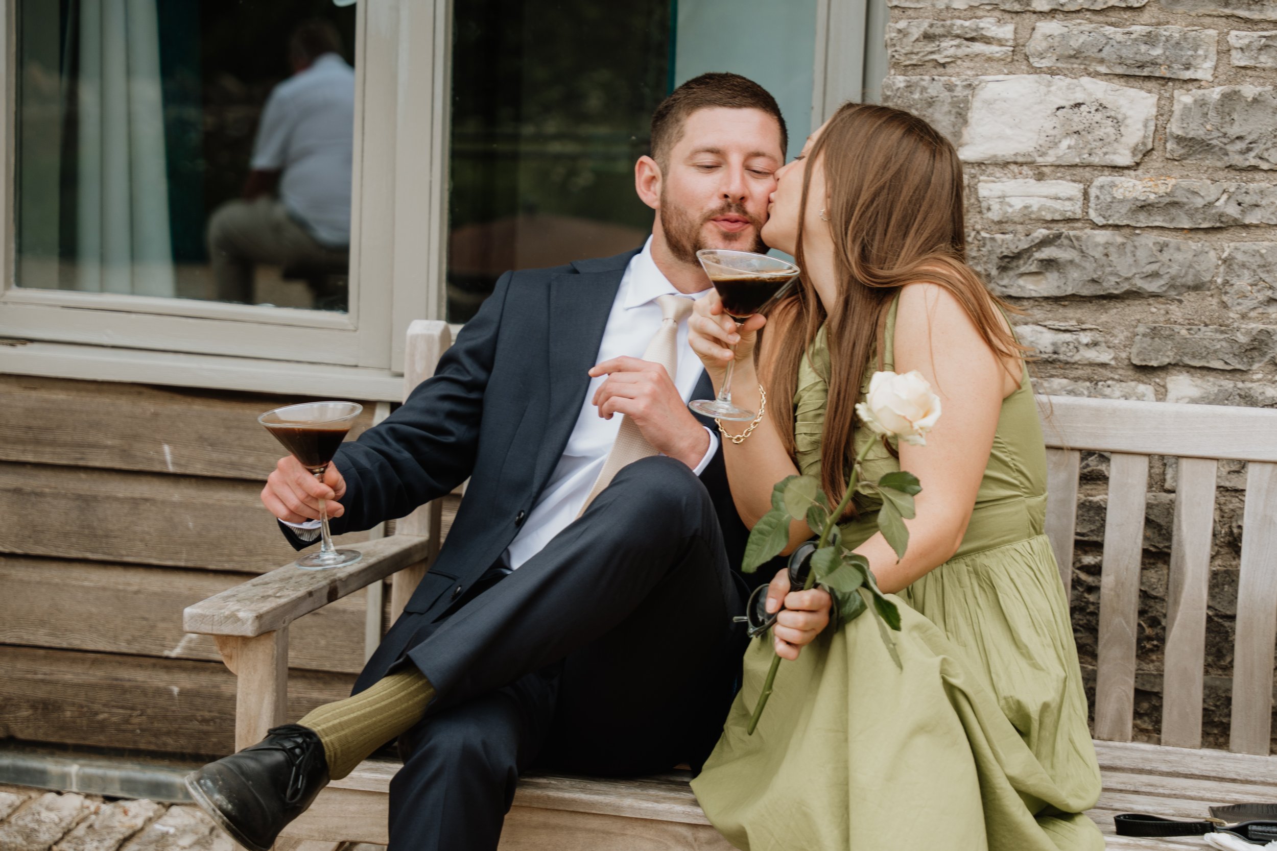 candid photo of wedding guests kissing