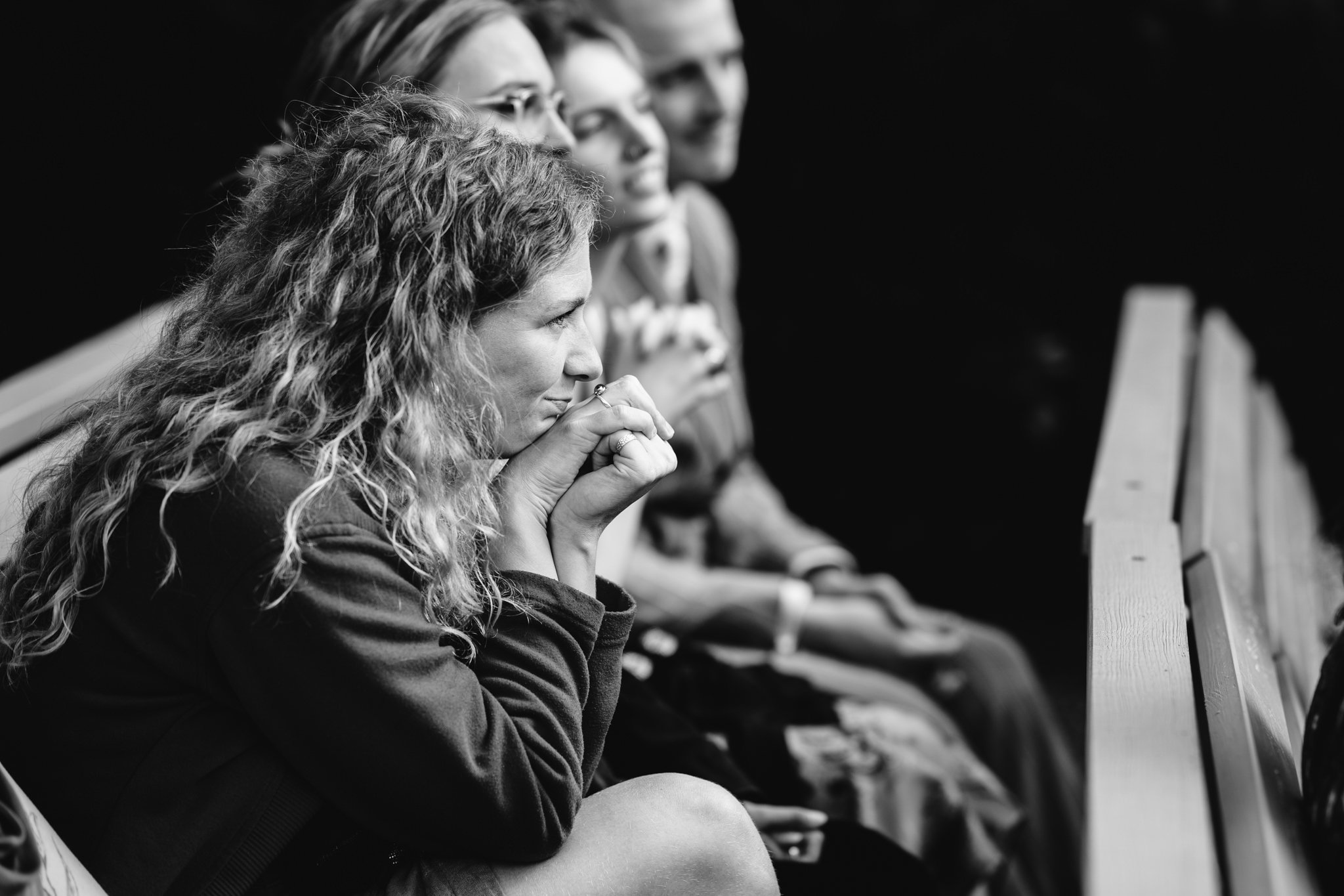 candid black and white photo of guest crying during outdoor ceremony
