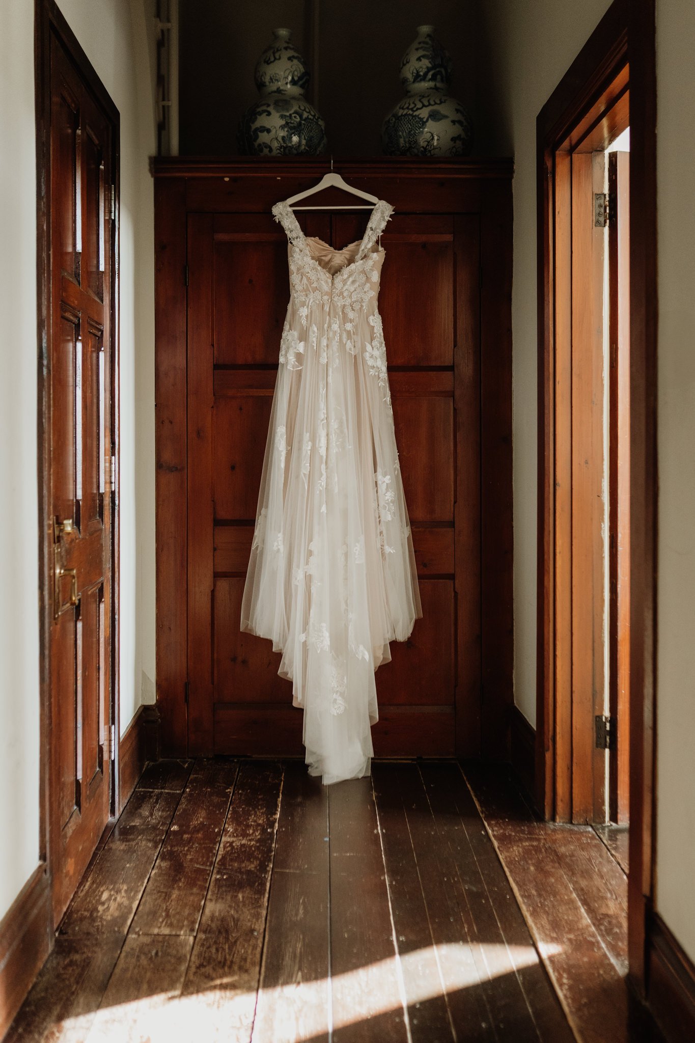 wedding dress hanging up on door