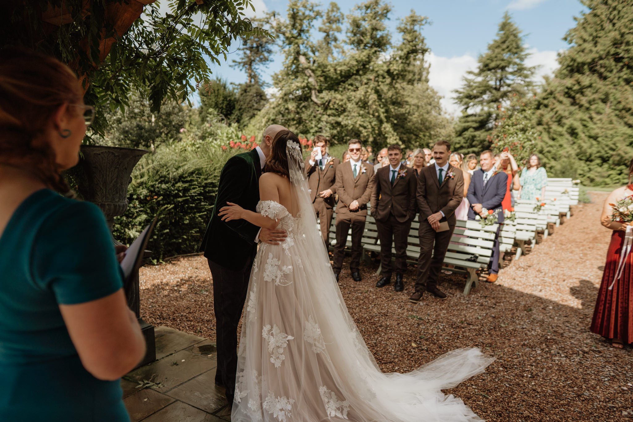 bride and groom kiss outside ceremony