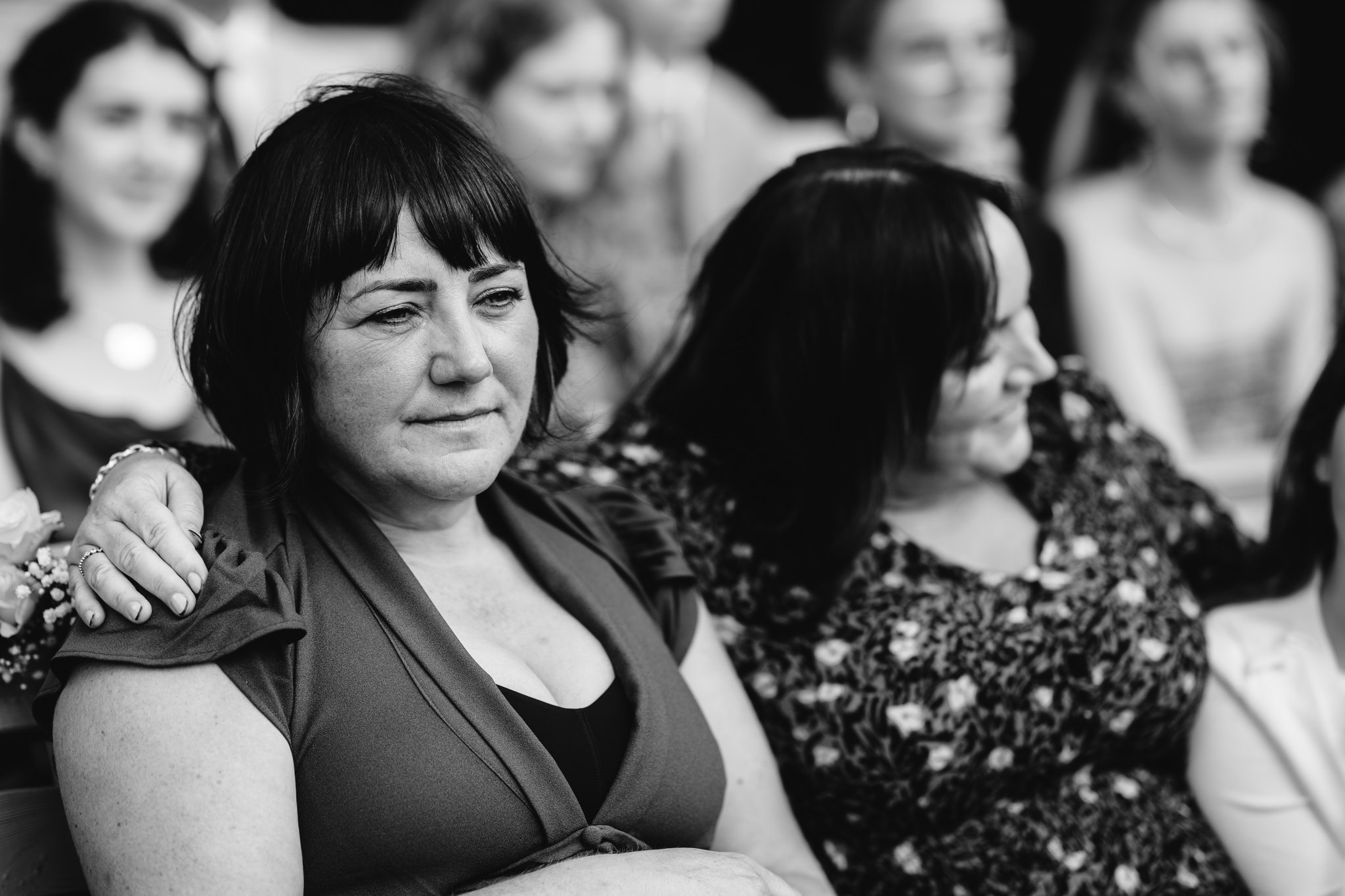 candid black and white photo of guest crying during outdoor ceremony