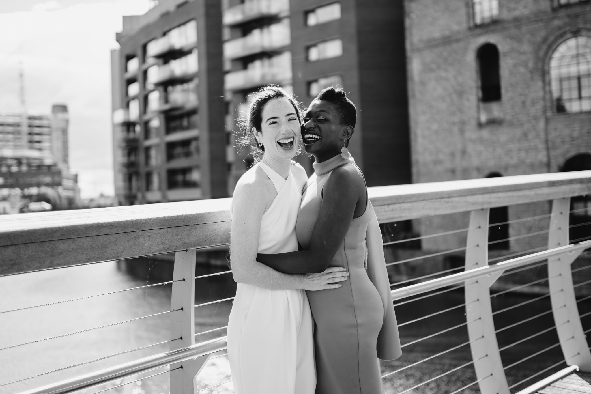 two brides laughing at the camera
