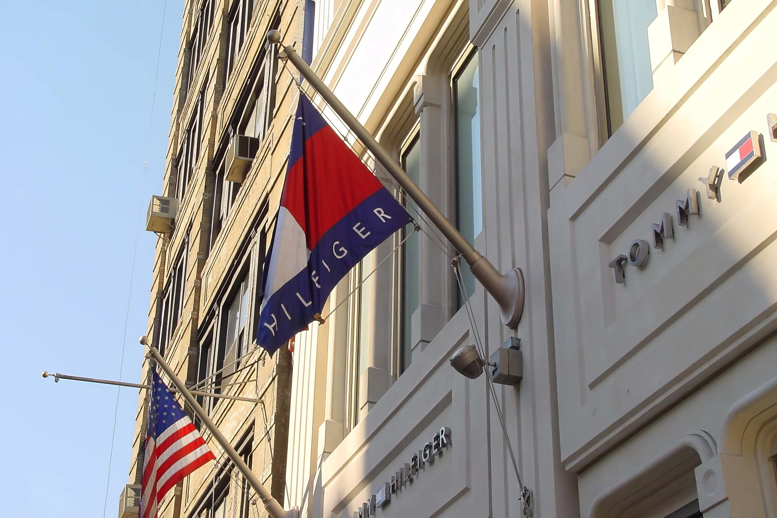 A building with multiple American flags hanging from flagpoles.