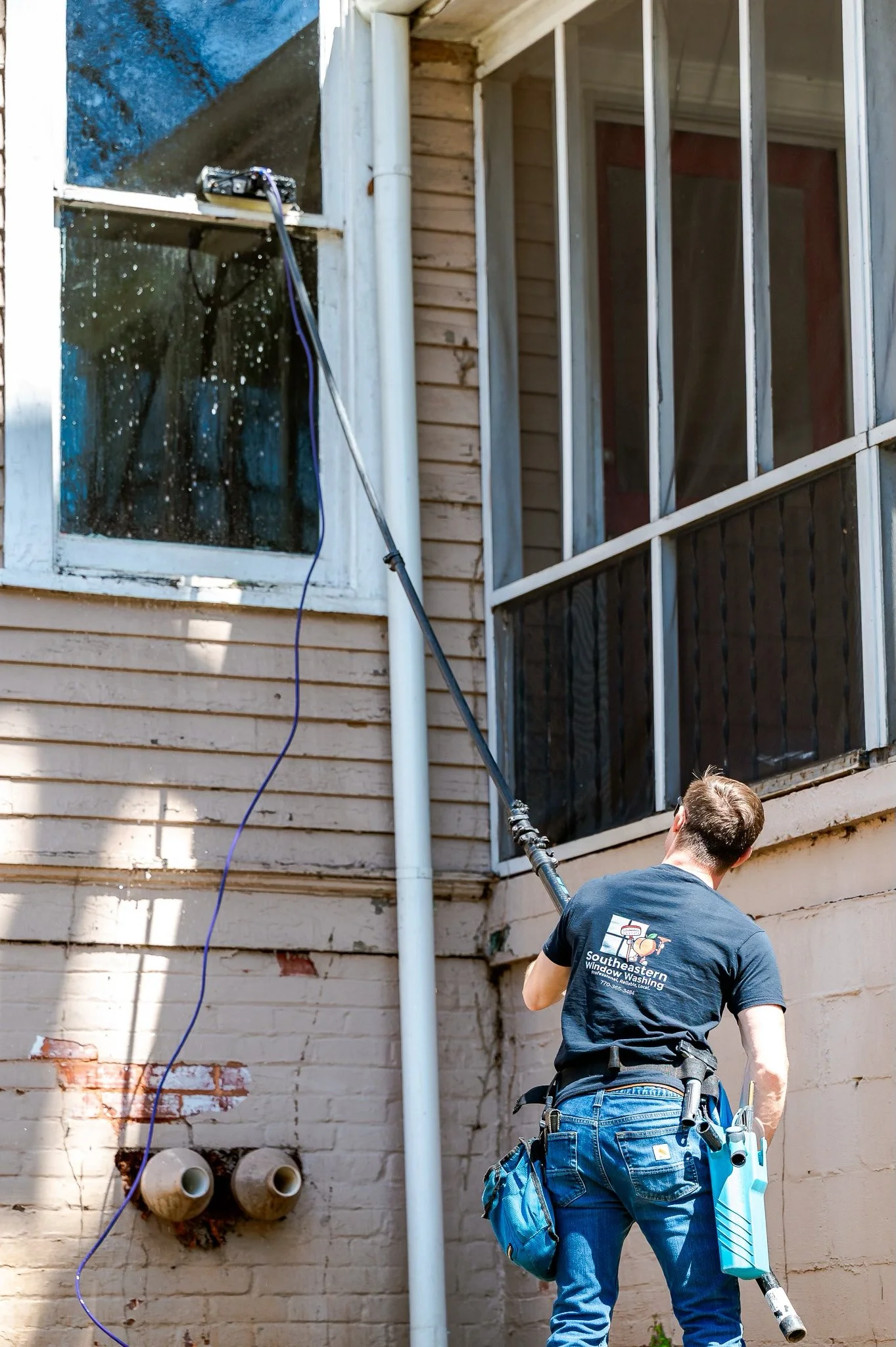 Worker-using-long-window-brush