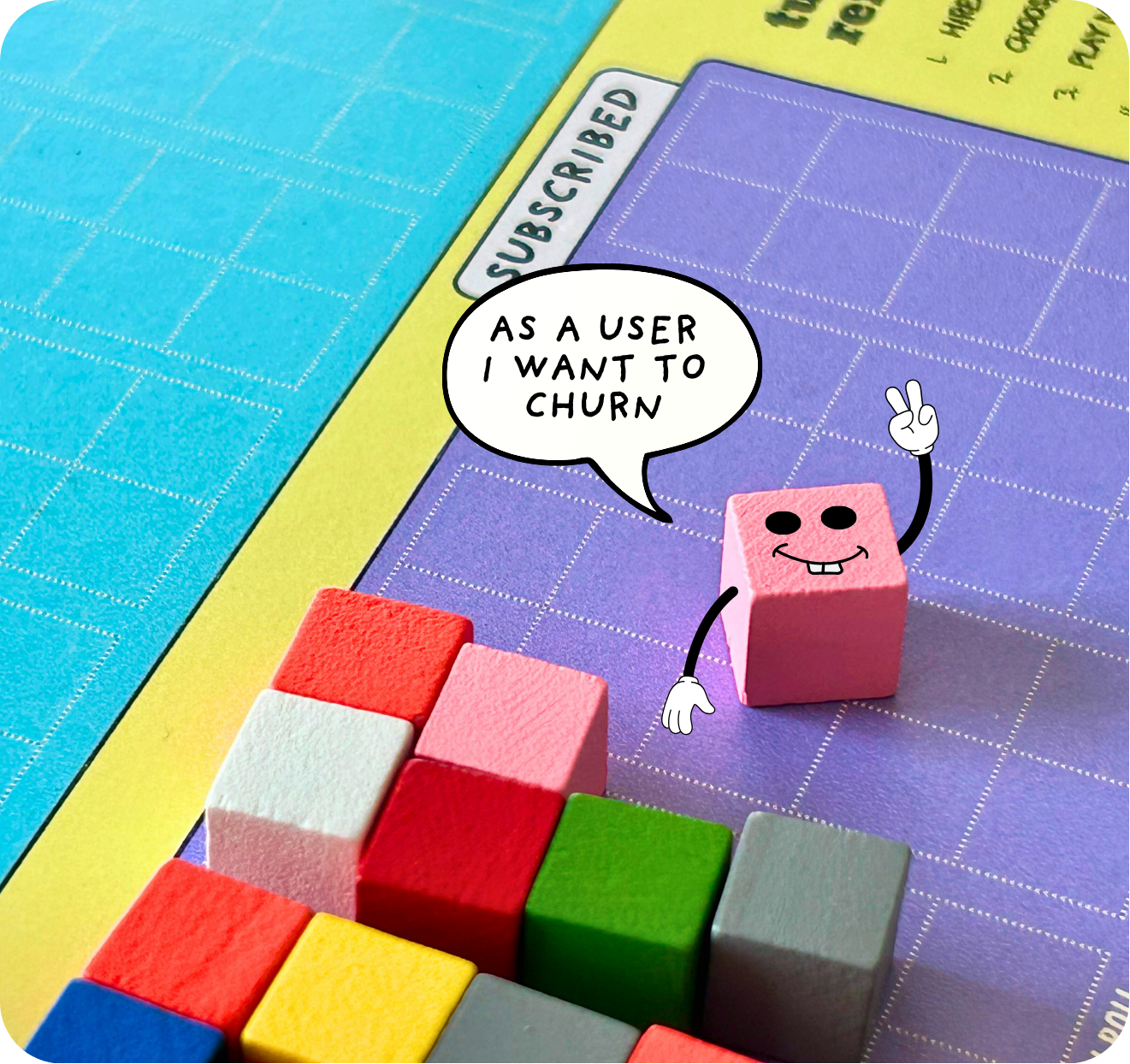 Colorful game board with wooden blocks and a cartoon pink cube character making a peace sign. The cube has a speech bubble saying 'As a user I want to churn' and is positioned on a purple grid.