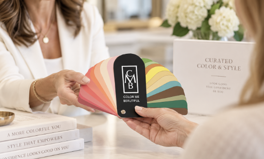 Sample color palette fan deck spread out on a wooden surface, showing various colors in a fan shape.