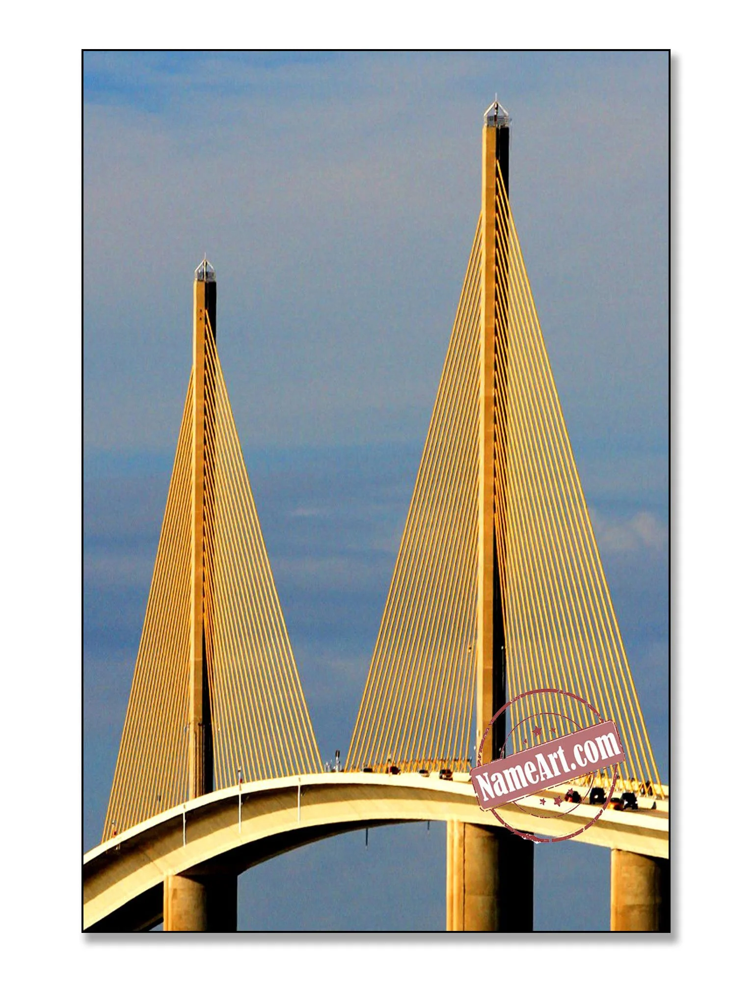 Bridge with two tall, pointed yellow towers and cables against a cloudy sky.