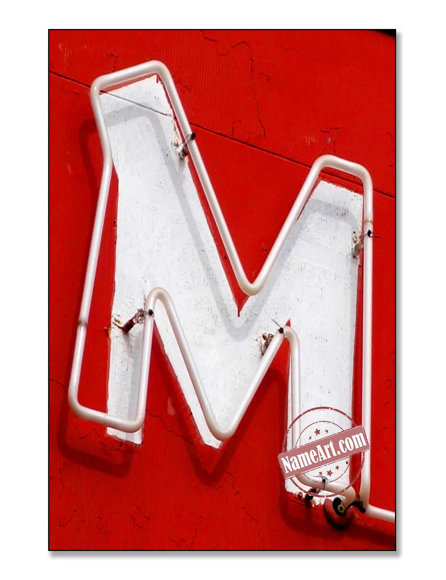 Neon sign in the shape of a downward arrow mounted on a red wall.