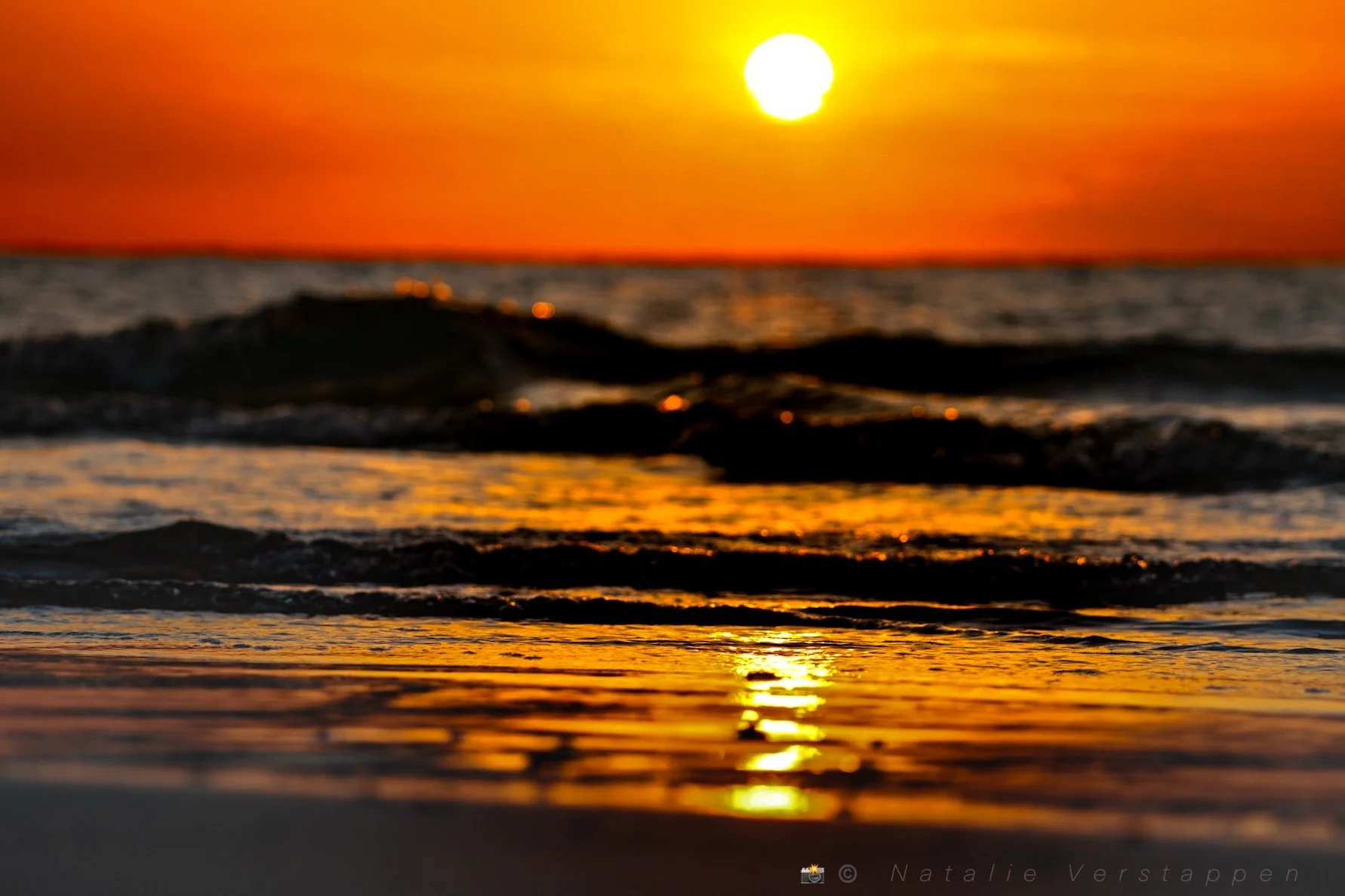 Waves coming ashore, covered in the golden hour sunset light