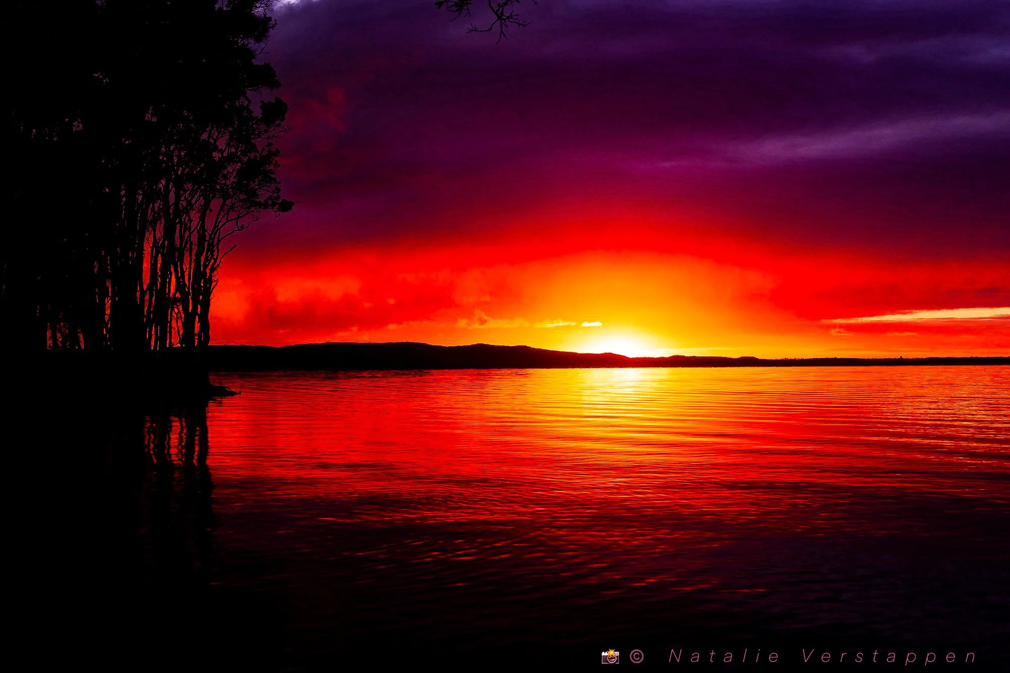 Fire the sky at sunrise coloring the water
