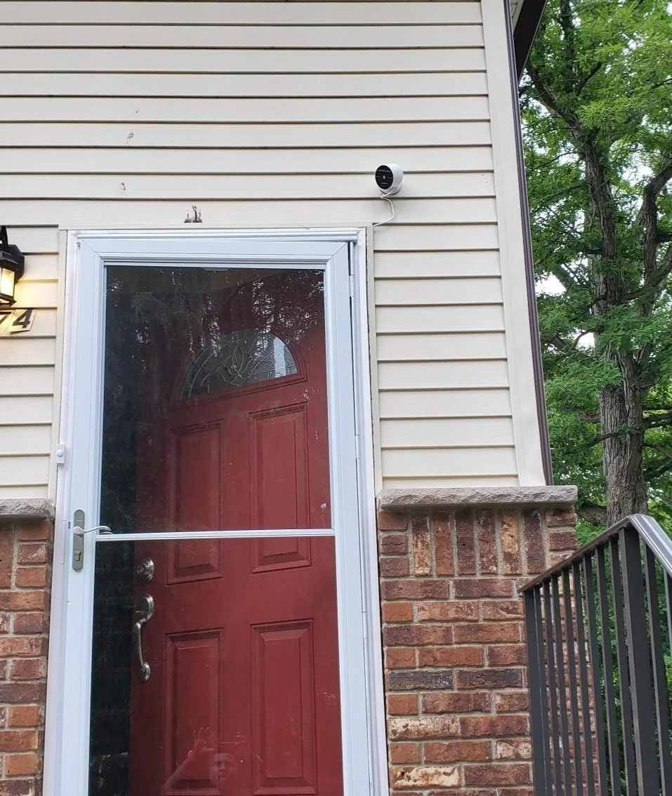 Camera on tan and red brick home on Front.jpg